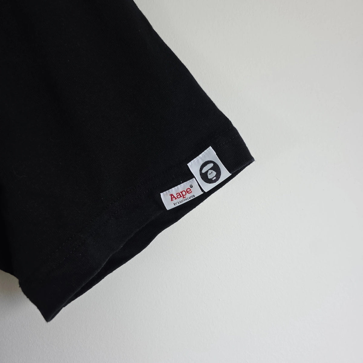 AAPE by A Bathing Ape black T-shirt with large camo ape head graphic and branded sleeve.