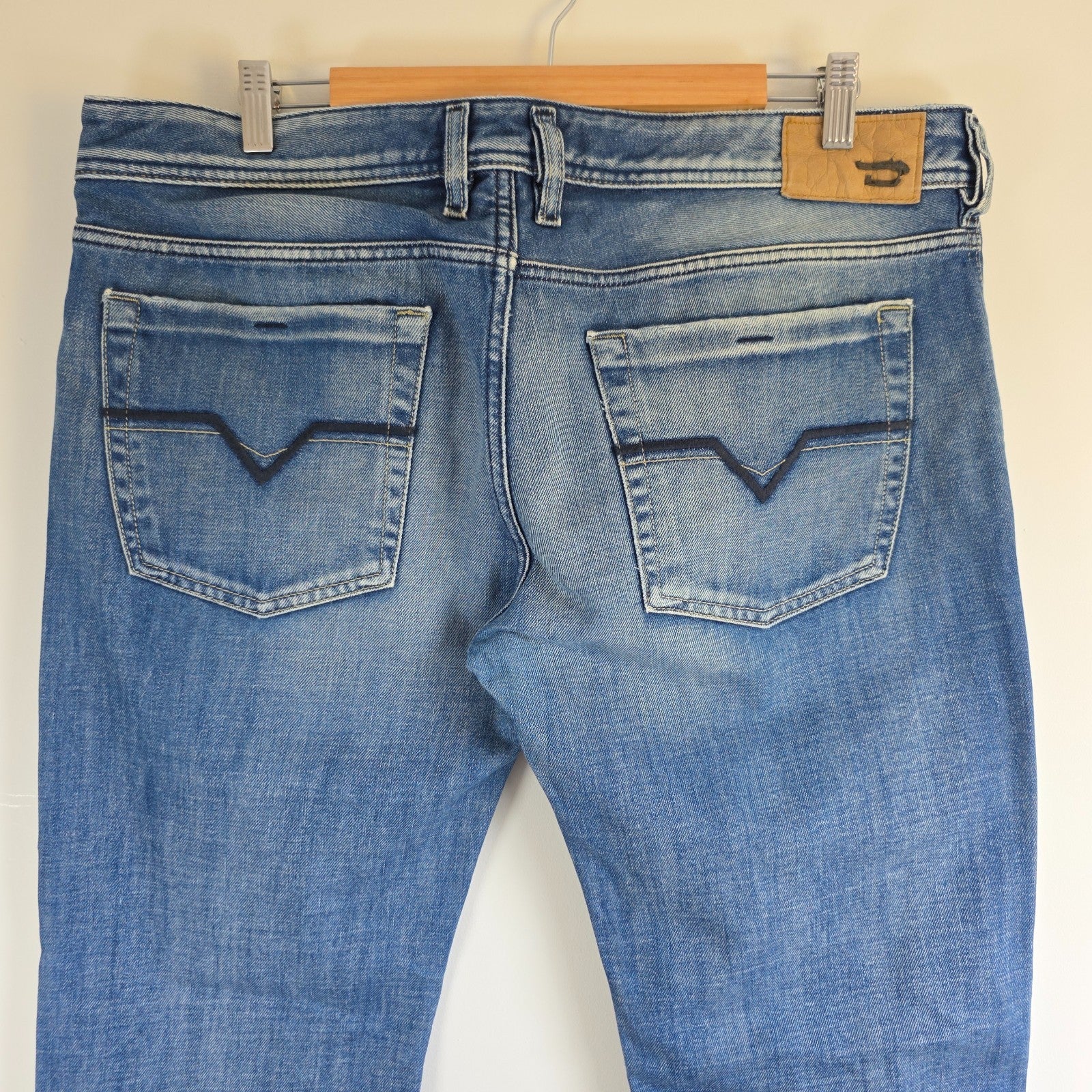 Diesel blue bootcut jeans with button fly and vintage Zathan fit, 100% cotton.
