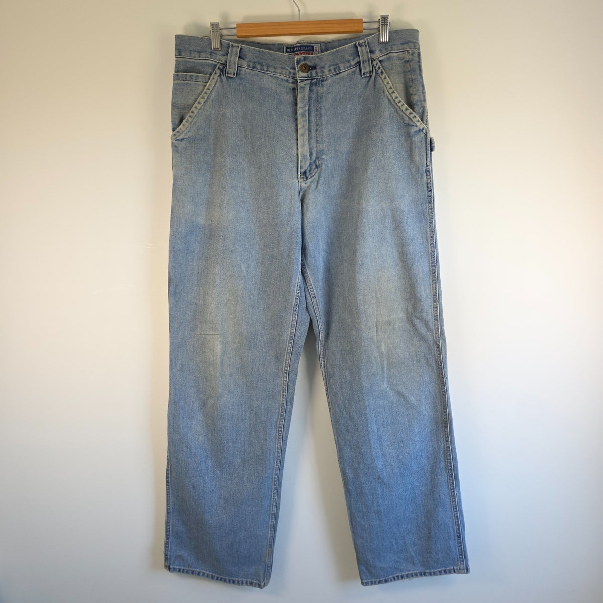 Old Navy blue carpenter jeans with hammer loop and utility pockets, 100% cotton.