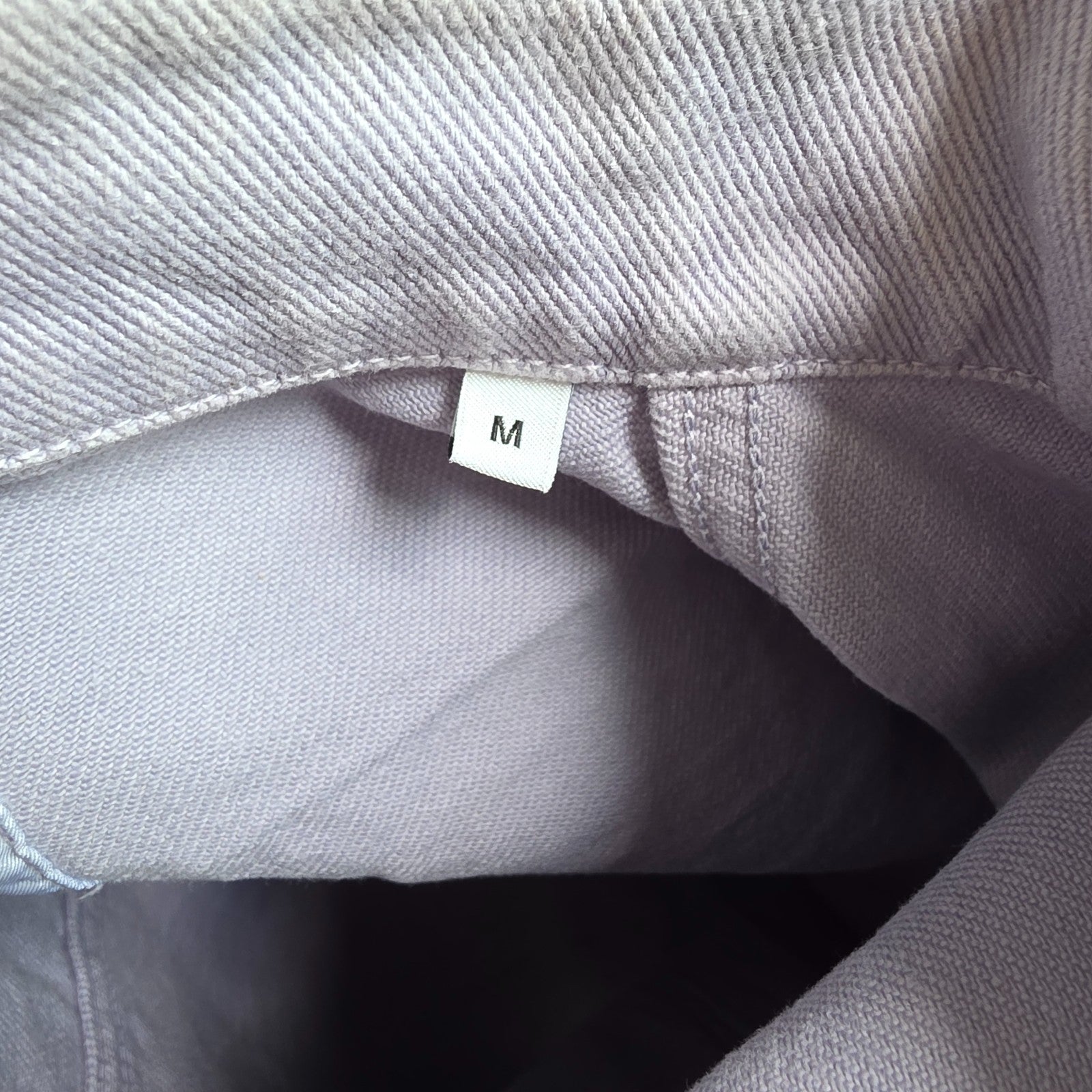 Albam lilac denim jacket with button front, chest pockets, and side pockets.