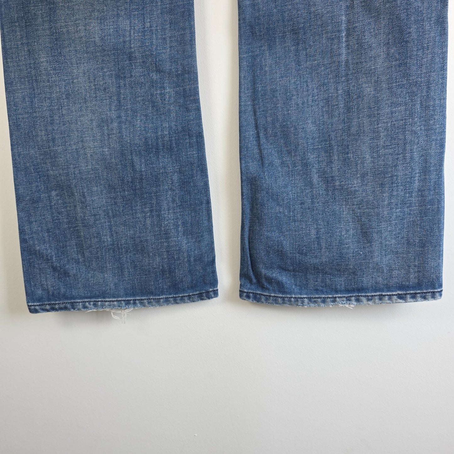 Diesel blue bootcut jeans with button fly and vintage Zathan fit, 100% cotton.
