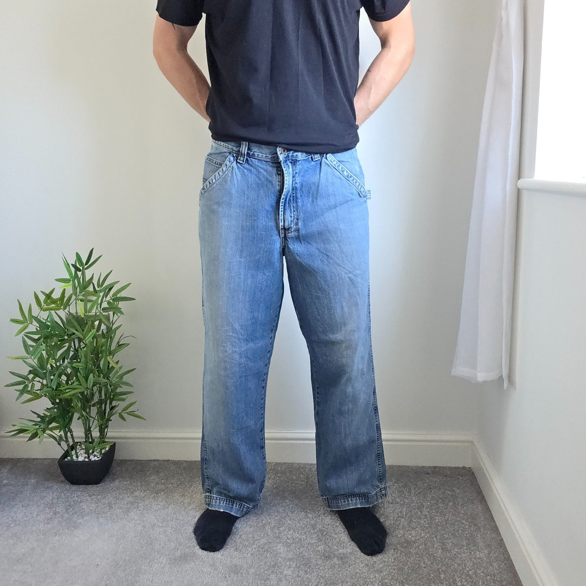 Old Navy blue carpenter jeans with hammer loop and utility pocket detailing.