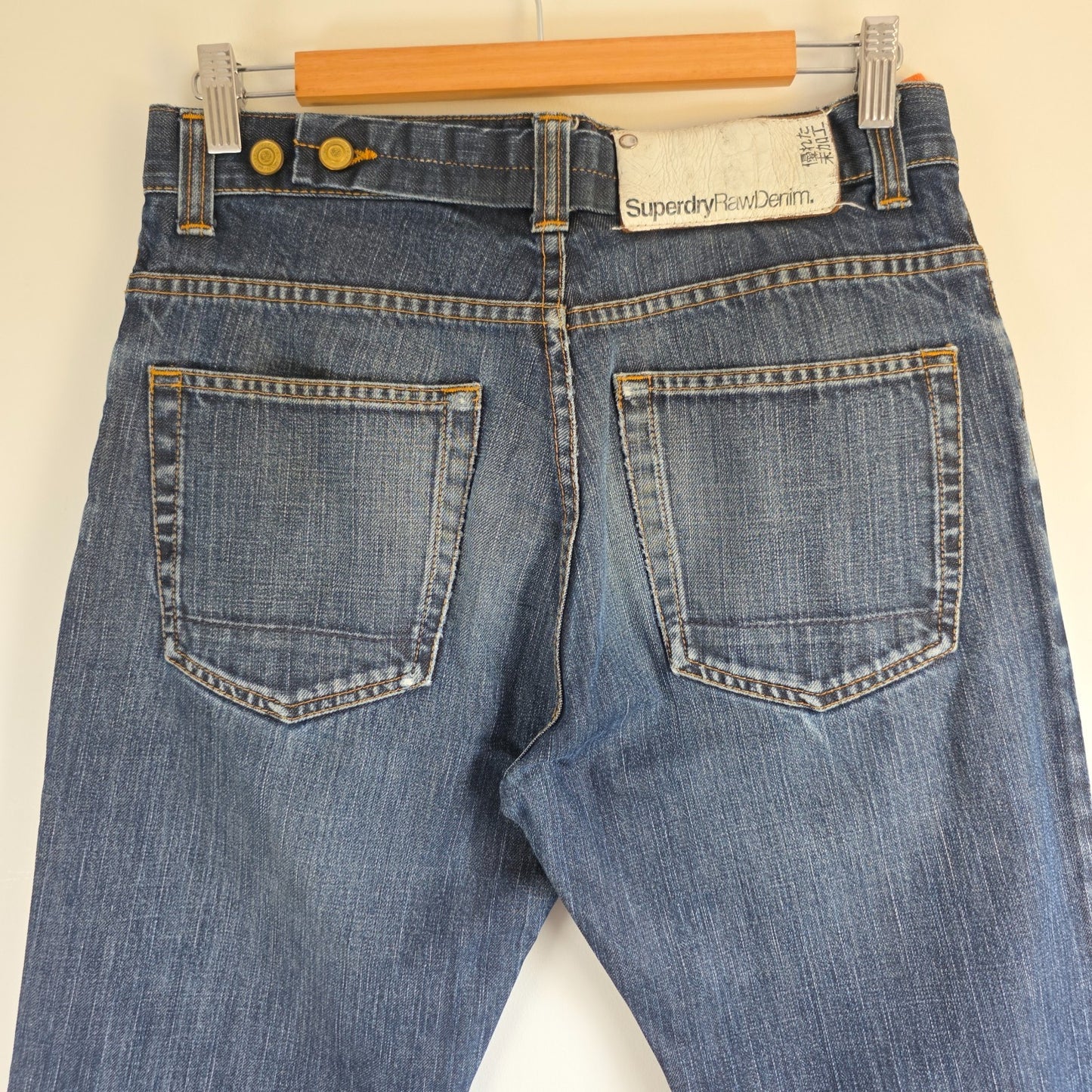 Superdry blue straight jeans with button fly, vintage raw denim, light wear.