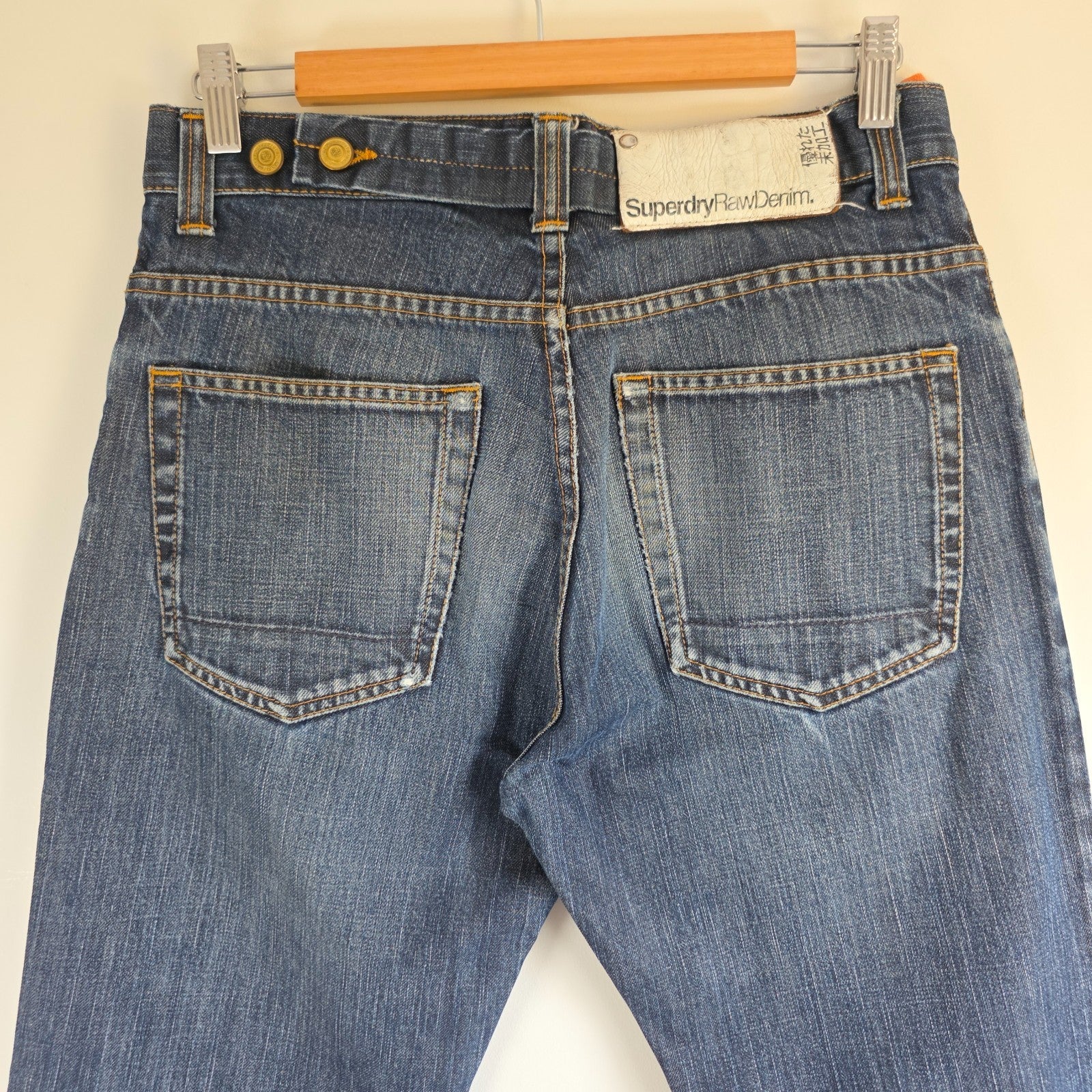 Superdry blue straight jeans with button fly, vintage raw denim, light wear.