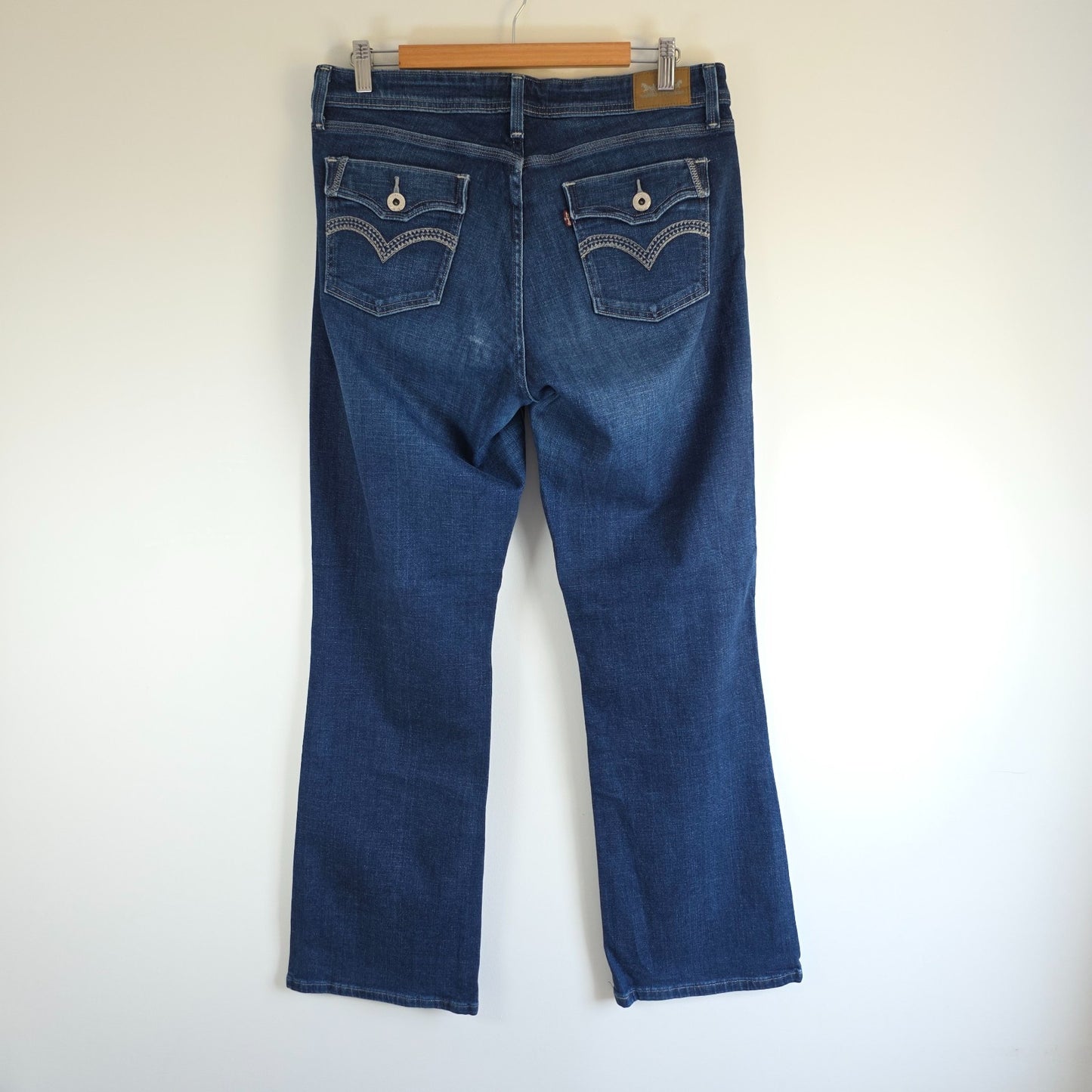 Levi's blue straight jeans with distressed details and classic 501 logo.