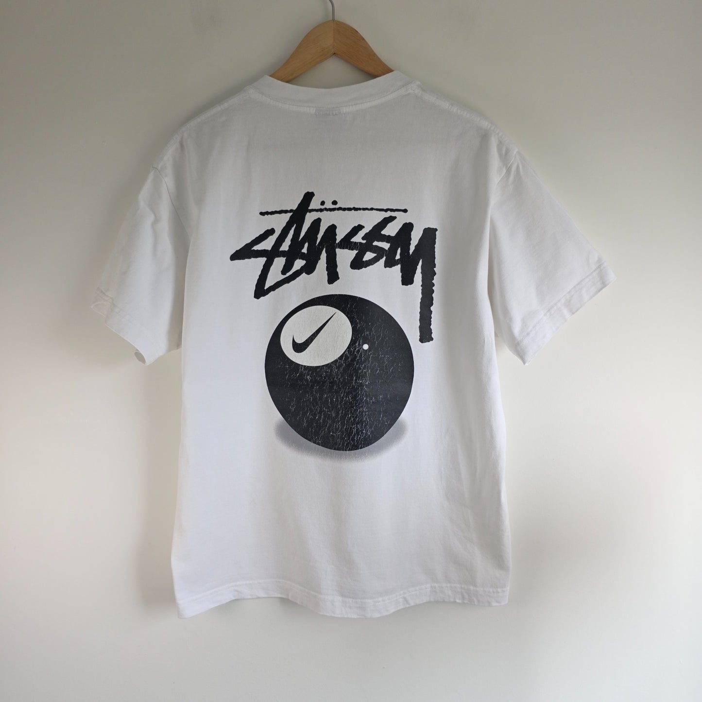 Stüssy x Nike white t-shirt with large 8 Ball back print and cotton material.