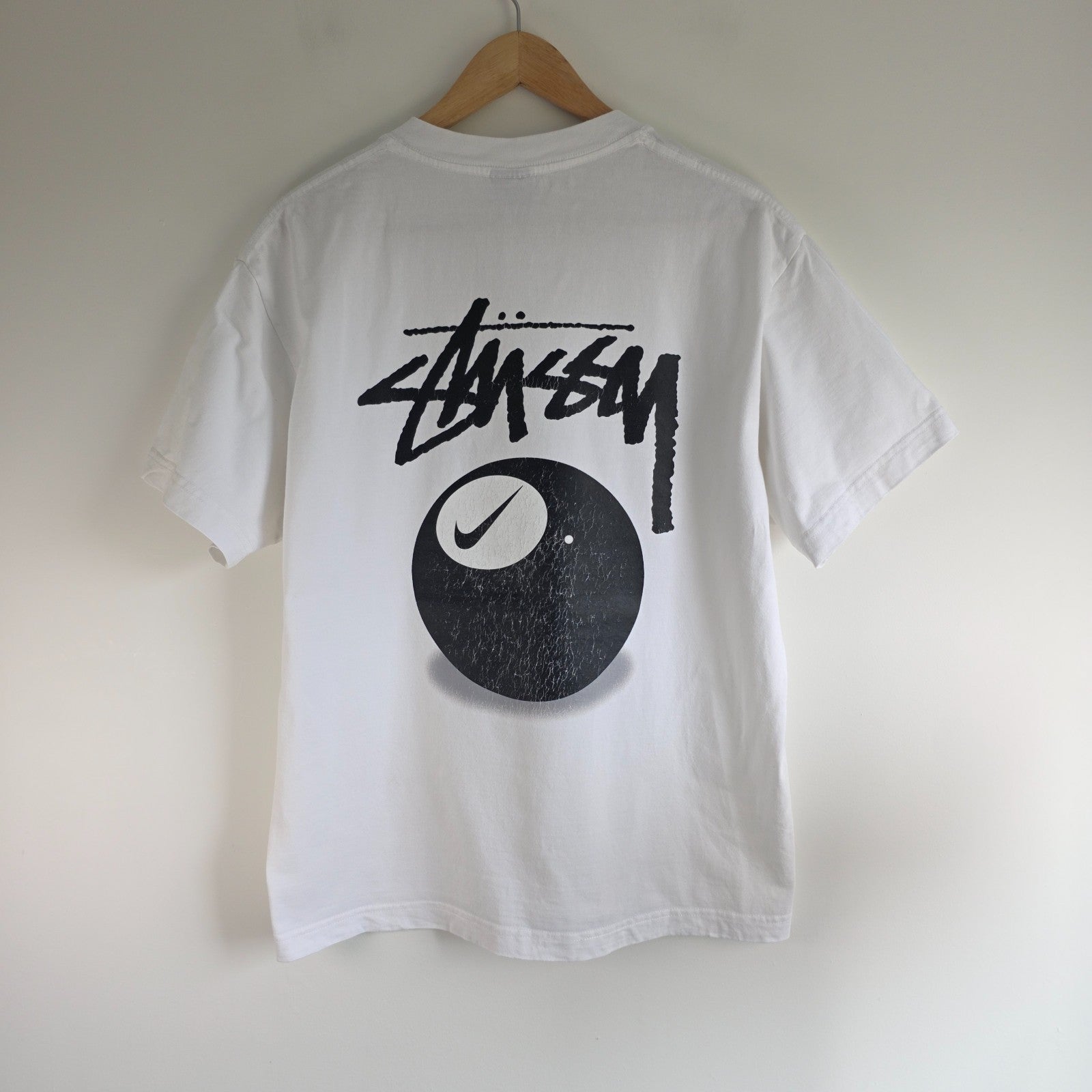 Stüssy x Nike white t-shirt with large 8 Ball back print and cotton material.