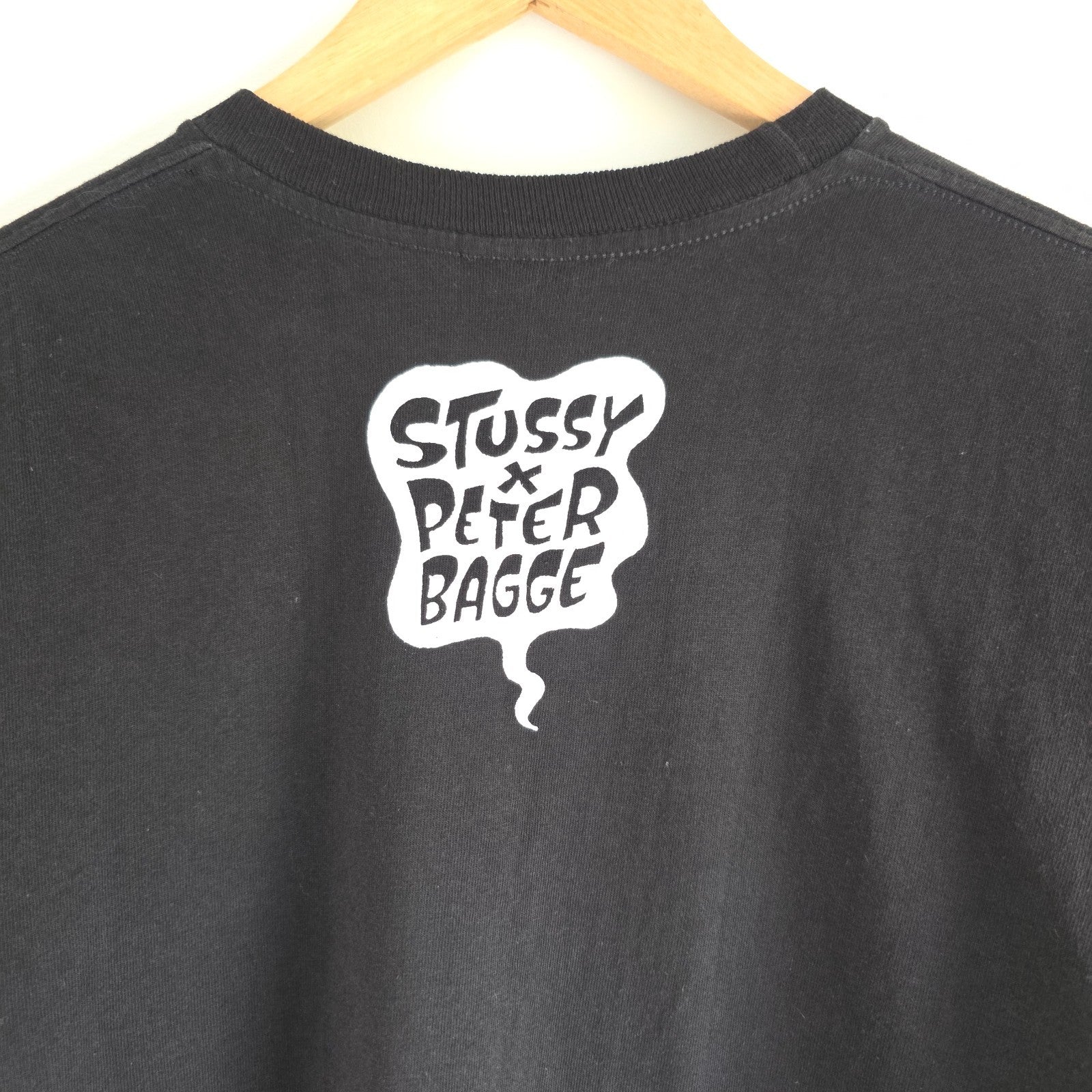 Stüssy black comic graphic t-shirt featuring large "Shout! Smash!" print, cotton material.