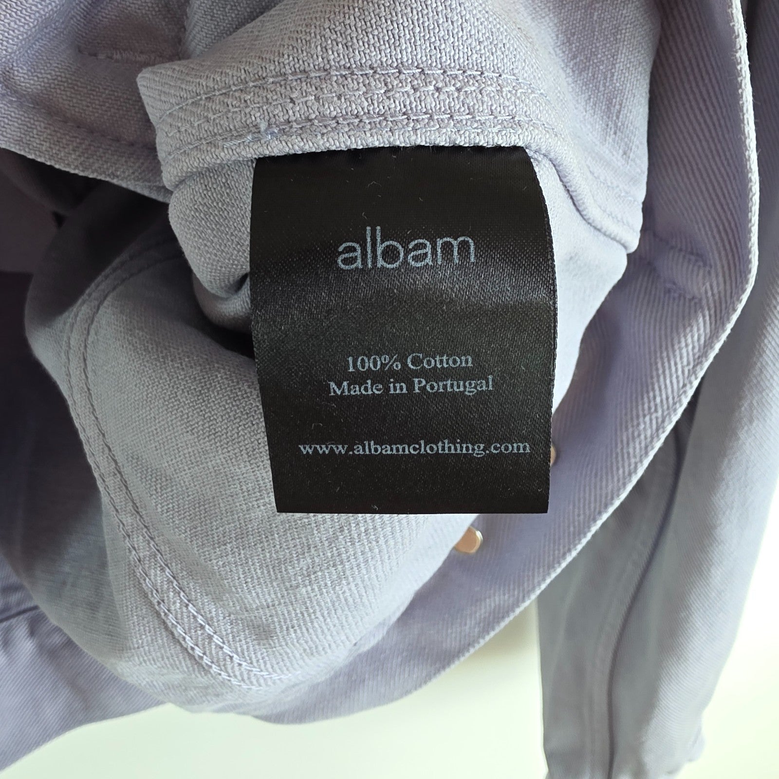 Albam lilac denim jacket with button front, chest pockets, and side pockets.