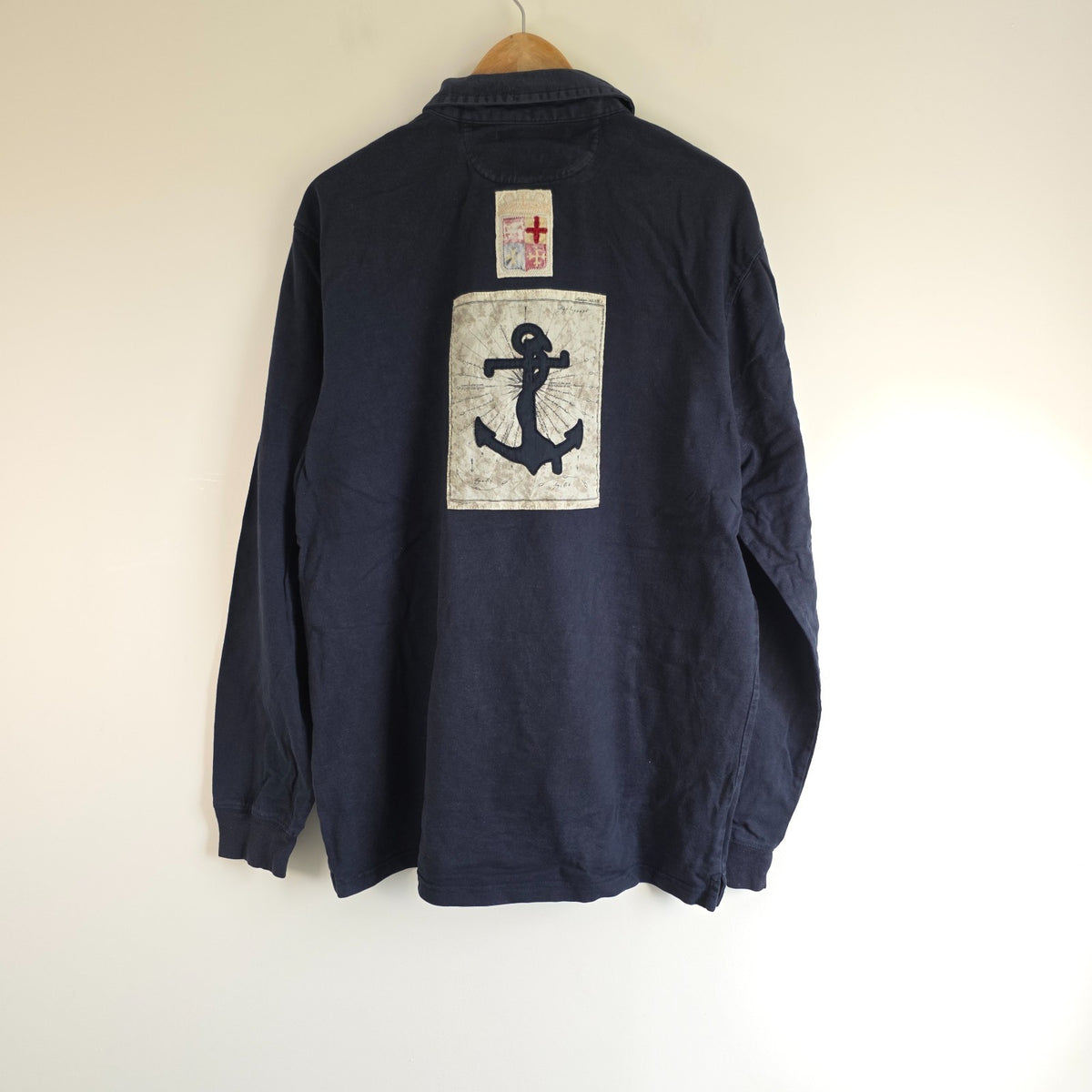 Marina Militare blue rugby shirt with embroidered crest and large nautical anchor appliqué.