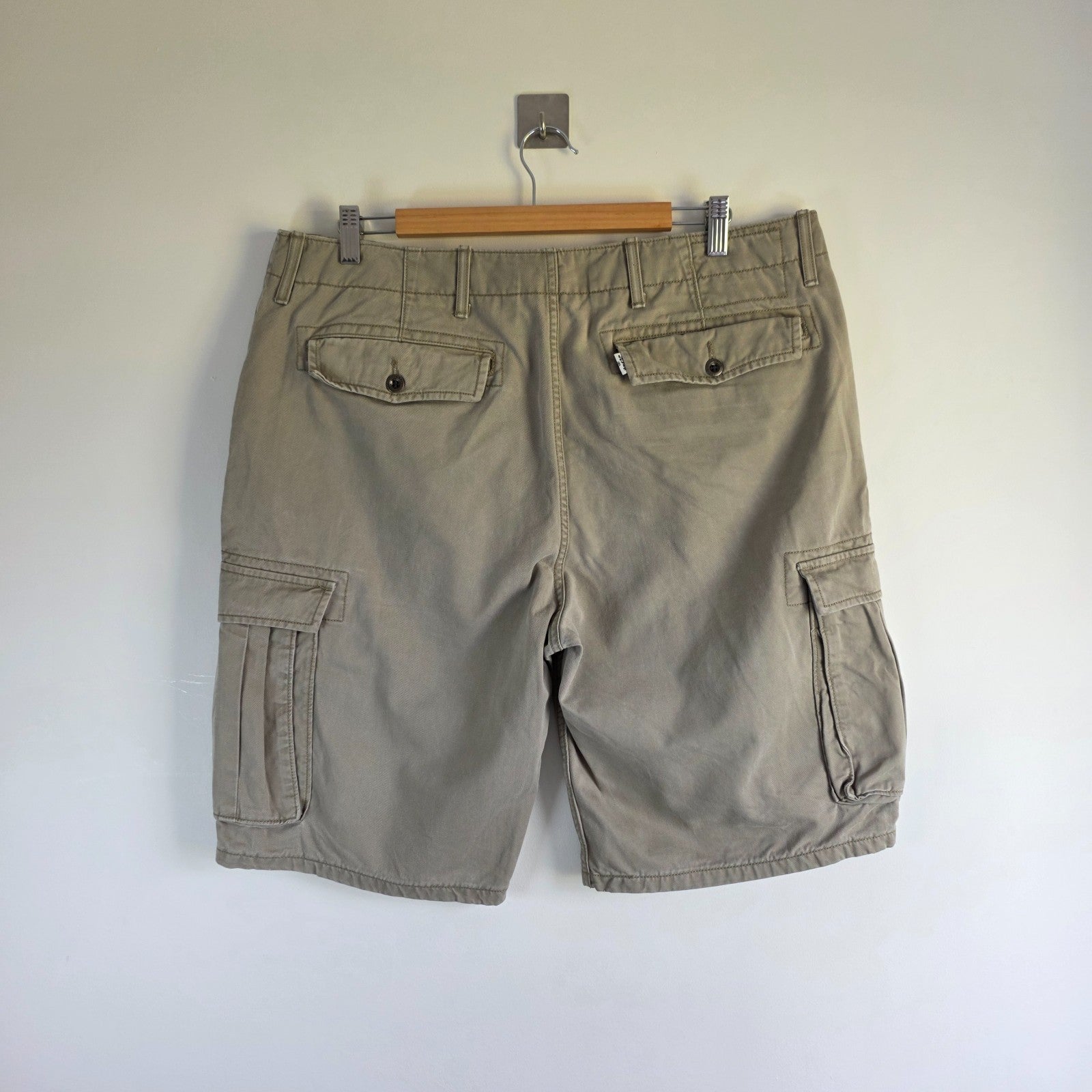 Levi's beige cargo shorts with utility pockets and cotton material, very good condition.