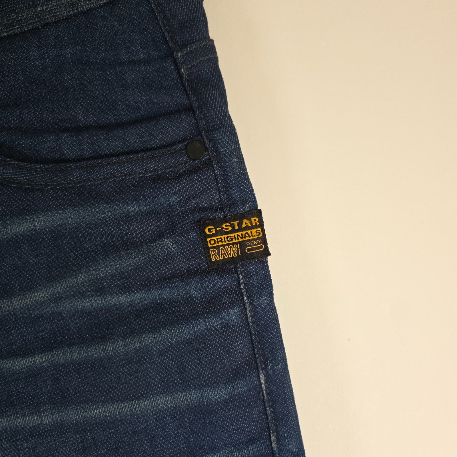 G-Star blue straight jeans with button fly and BNWT tag, cotton elastane blend.
