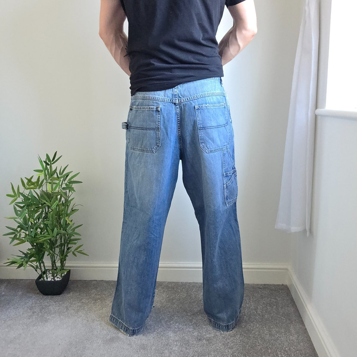 Old Navy blue carpenter jeans with hammer loop and utility pocket detailing.