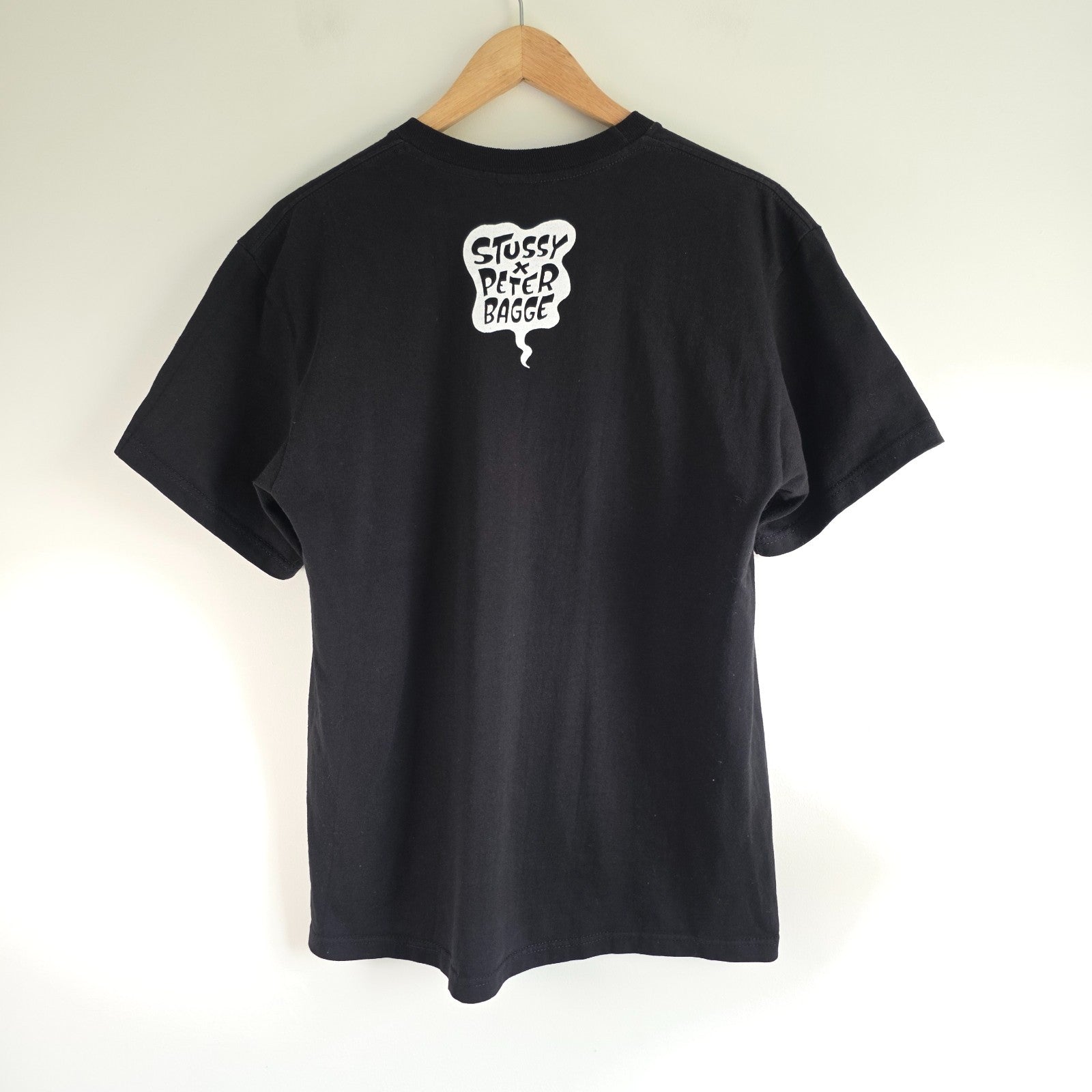 Stüssy black comic graphic t-shirt featuring large "Shout! Smash!" print, cotton material.