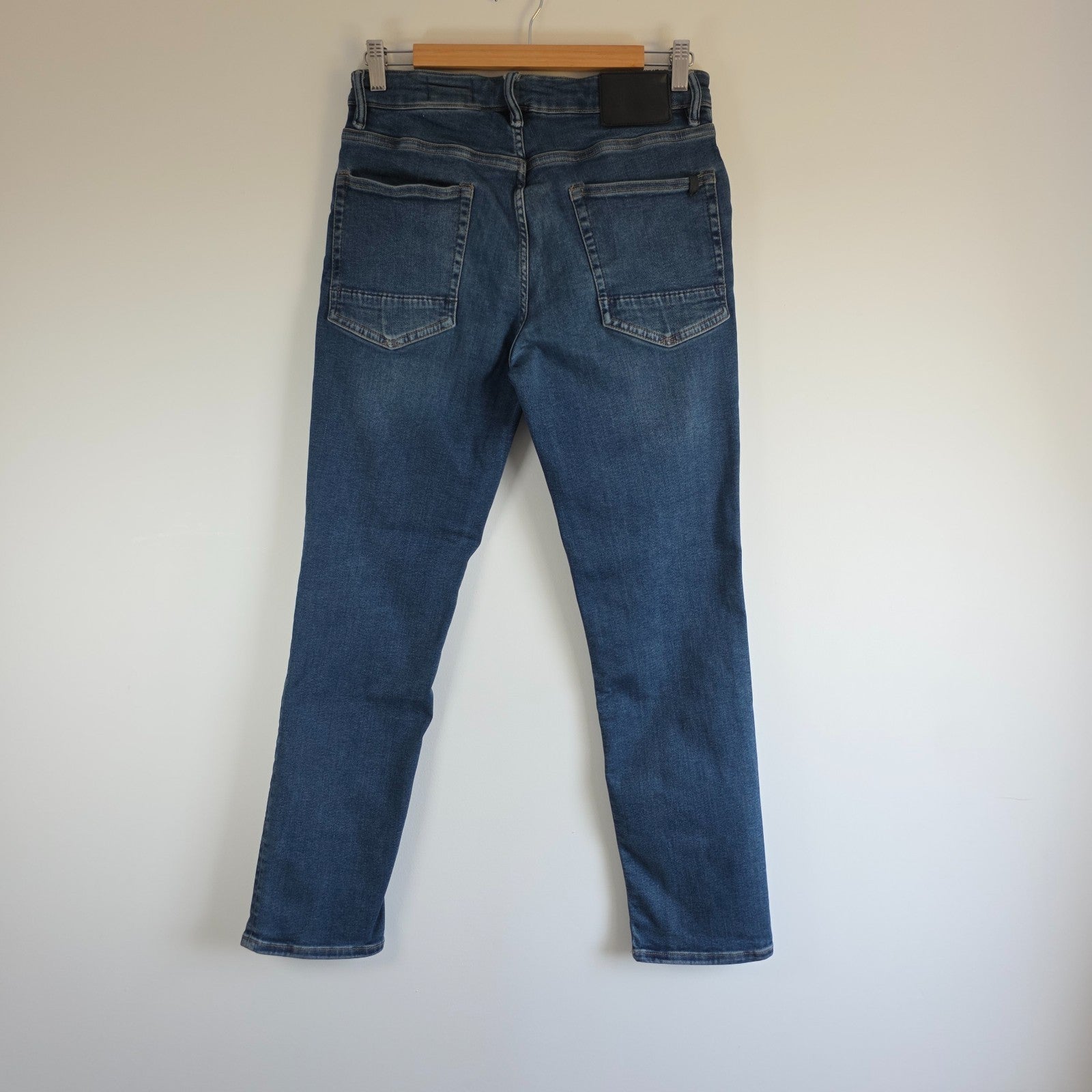 AllSaints blue straight jeans with button fly and stretch cotton-elastane blend.