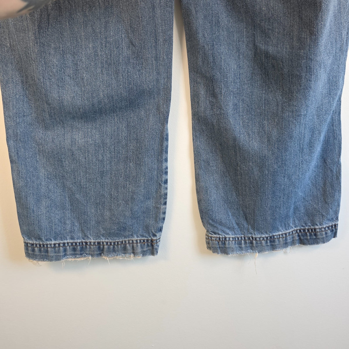 Old Navy blue carpenter jeans with hammer loop and utility pocket detailing.