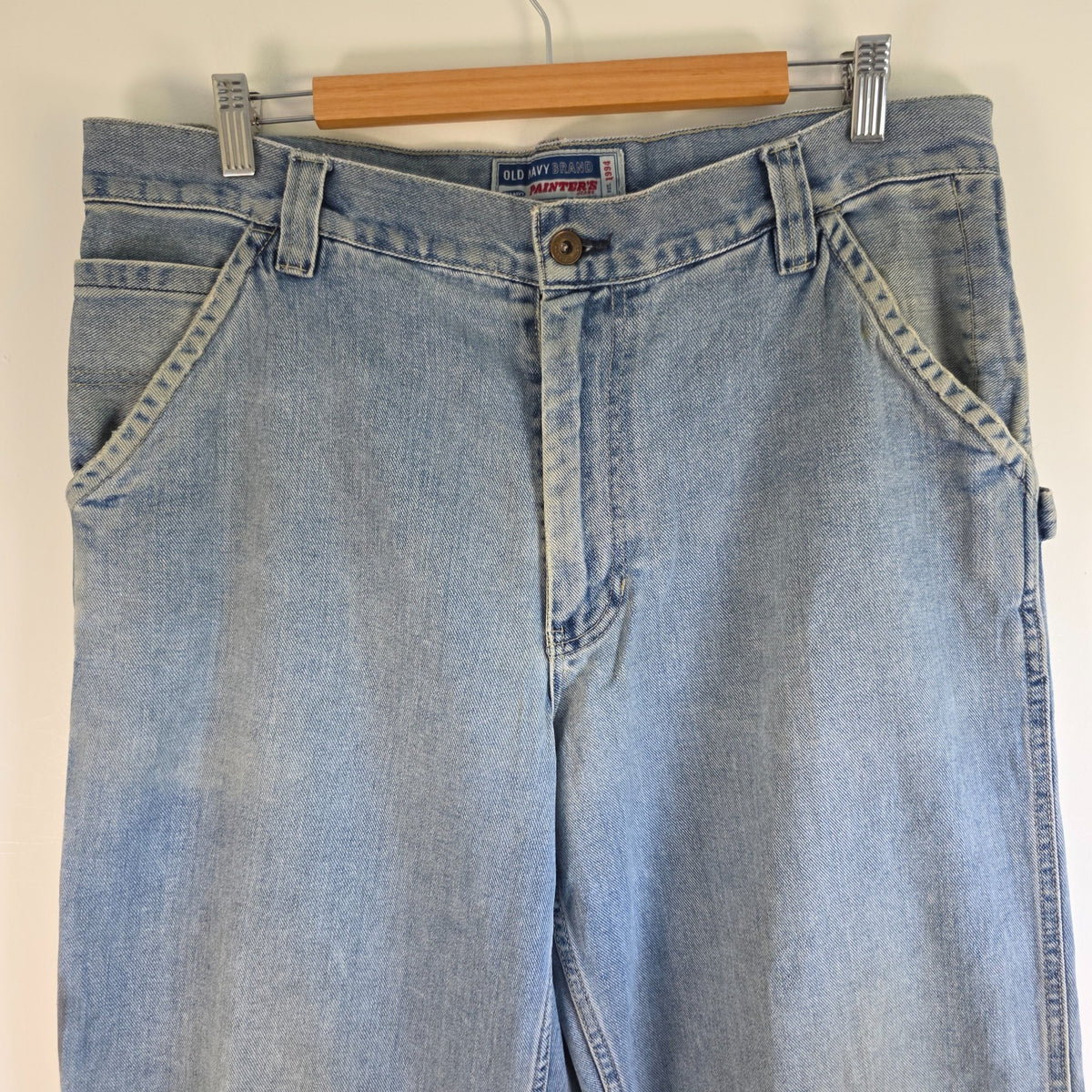 Old Navy blue carpenter jeans with hammer loop and utility pockets, 100% cotton.