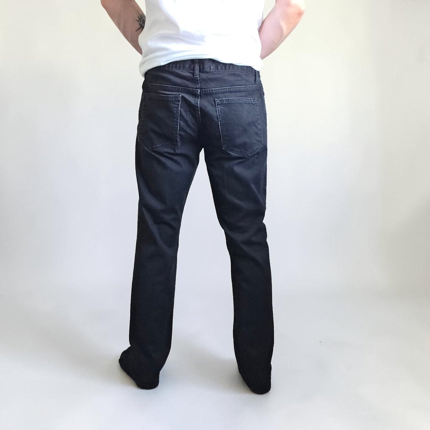 Calvin Klein black straight jeans with logo patch, stretch cotton blend, slim fit design.