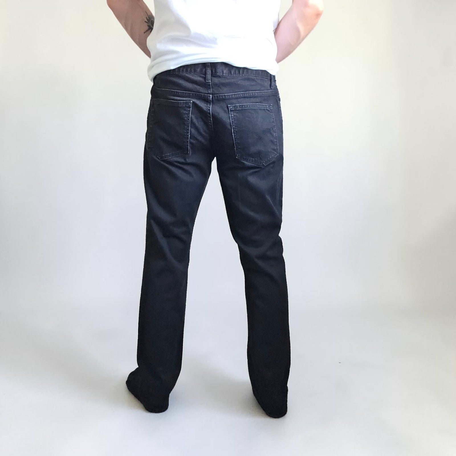 Calvin Klein black straight jeans with logo patch, stretch cotton blend, slim fit design.