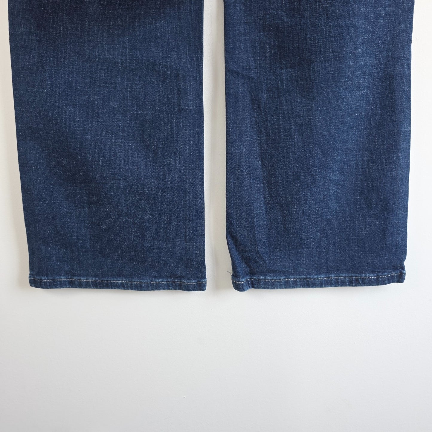 Levi's blue straight jeans with distressed details and classic 501 logo.