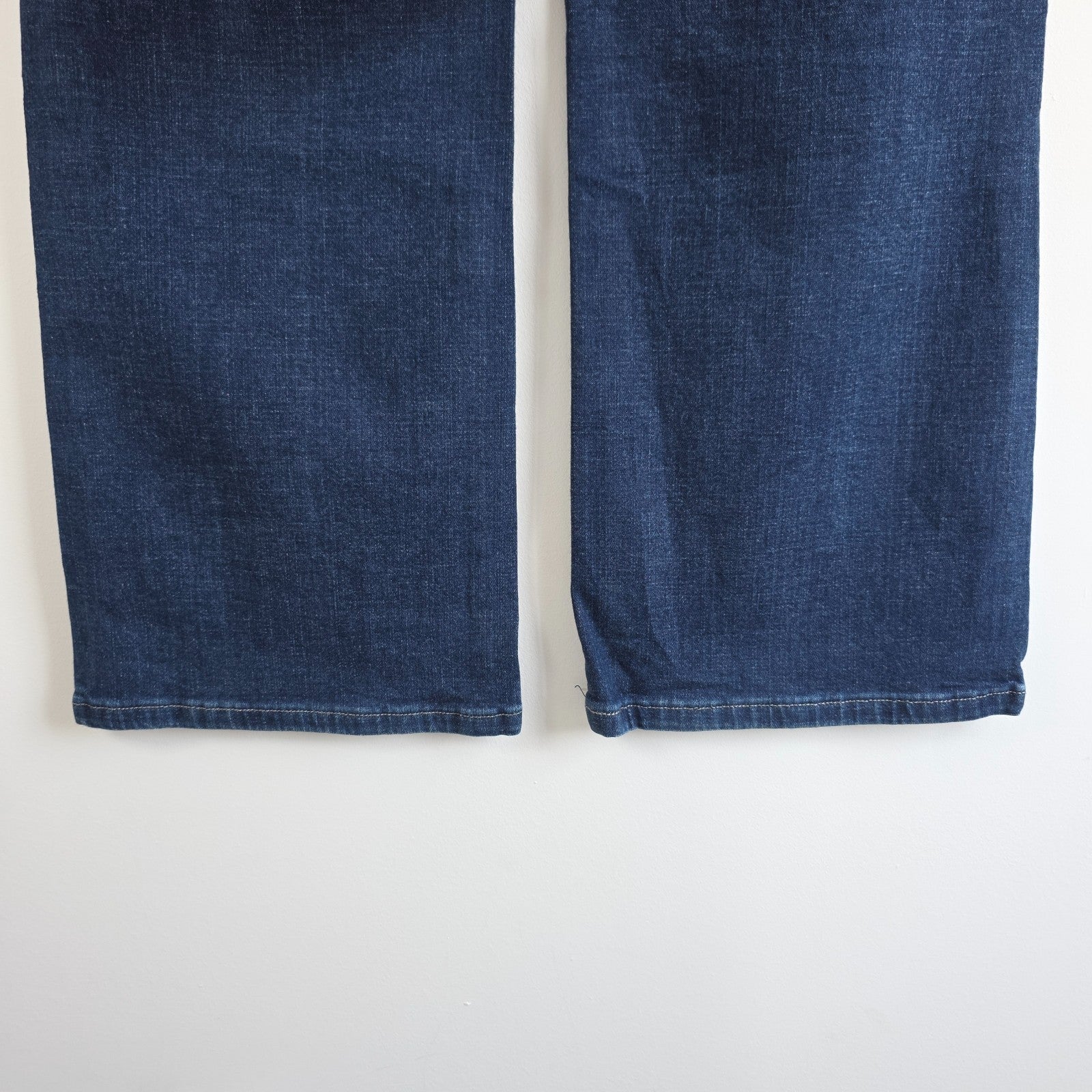 Levi's blue straight jeans with distressed details and classic 501 logo.