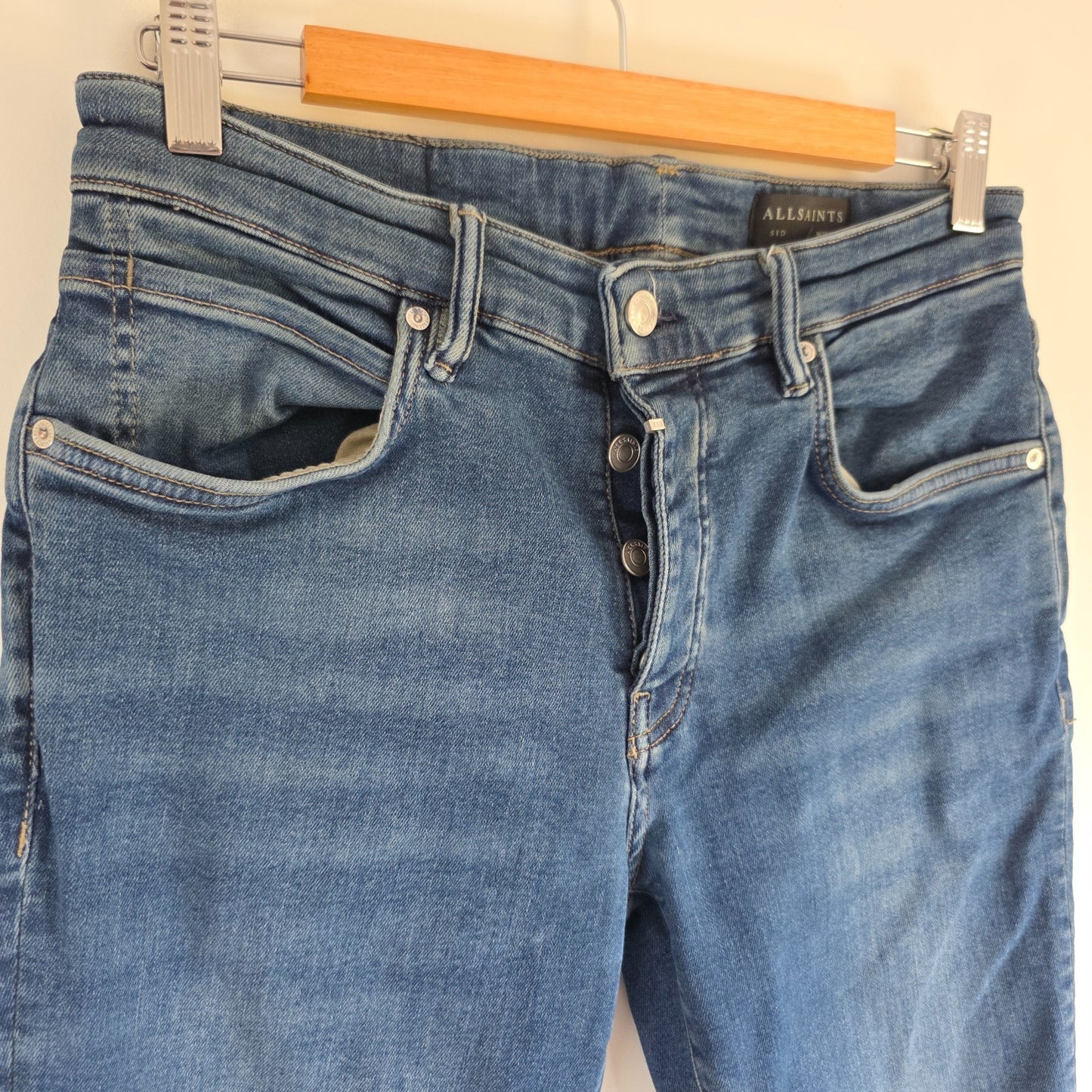 AllSaints blue straight jeans with button fly and stretch cotton-elastane blend.