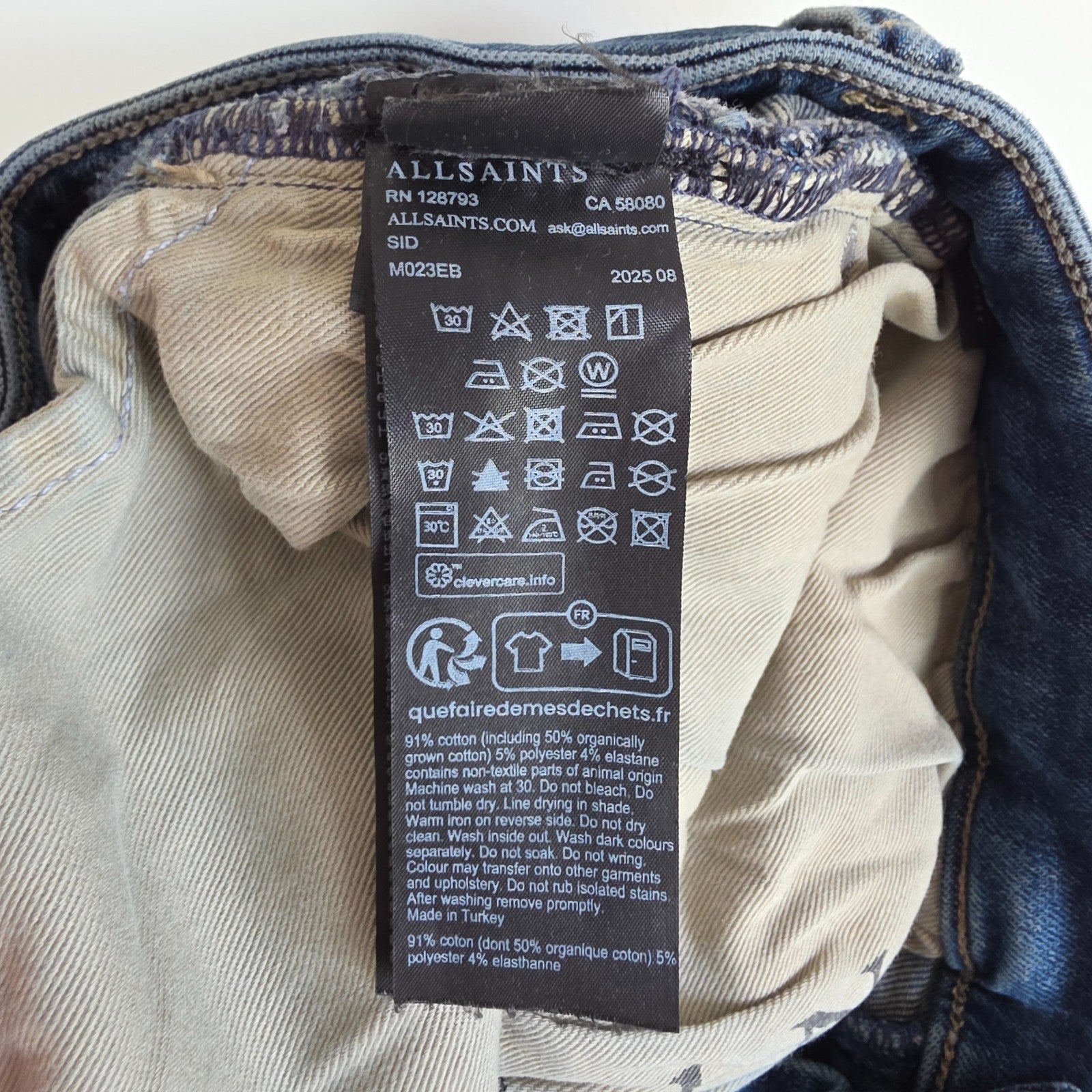 AllSaints blue straight jeans with button fly and stretch cotton-elastane blend.