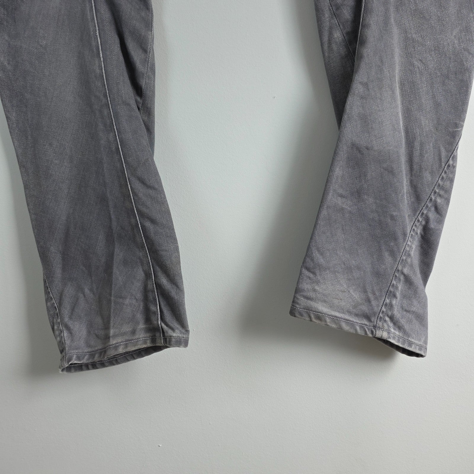 G-Star grey straight jeans with biker style detailing and subtle wear at the hem.