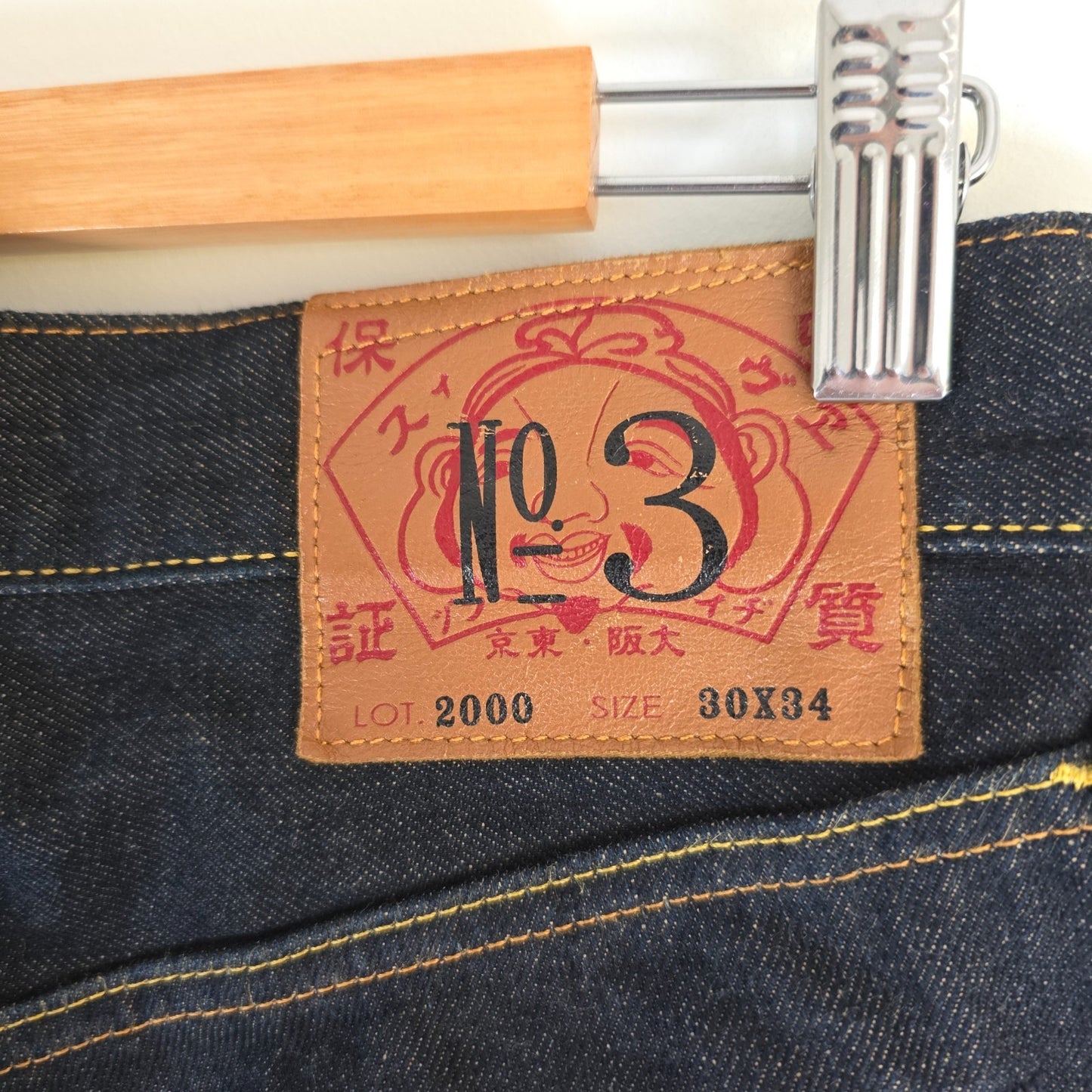 Evisu blue straight jeans with selvedge denim and button fly detailing.
