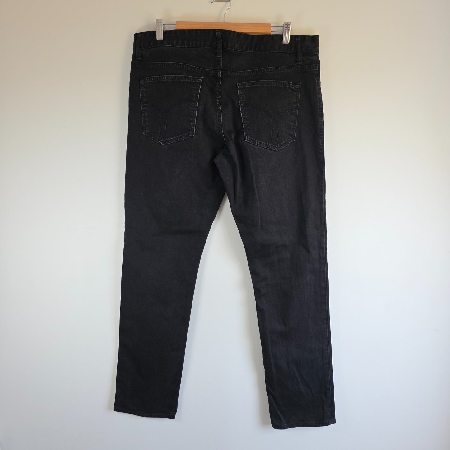 Calvin Klein black straight jeans with logo patch, stretch cotton blend, slim fit design.