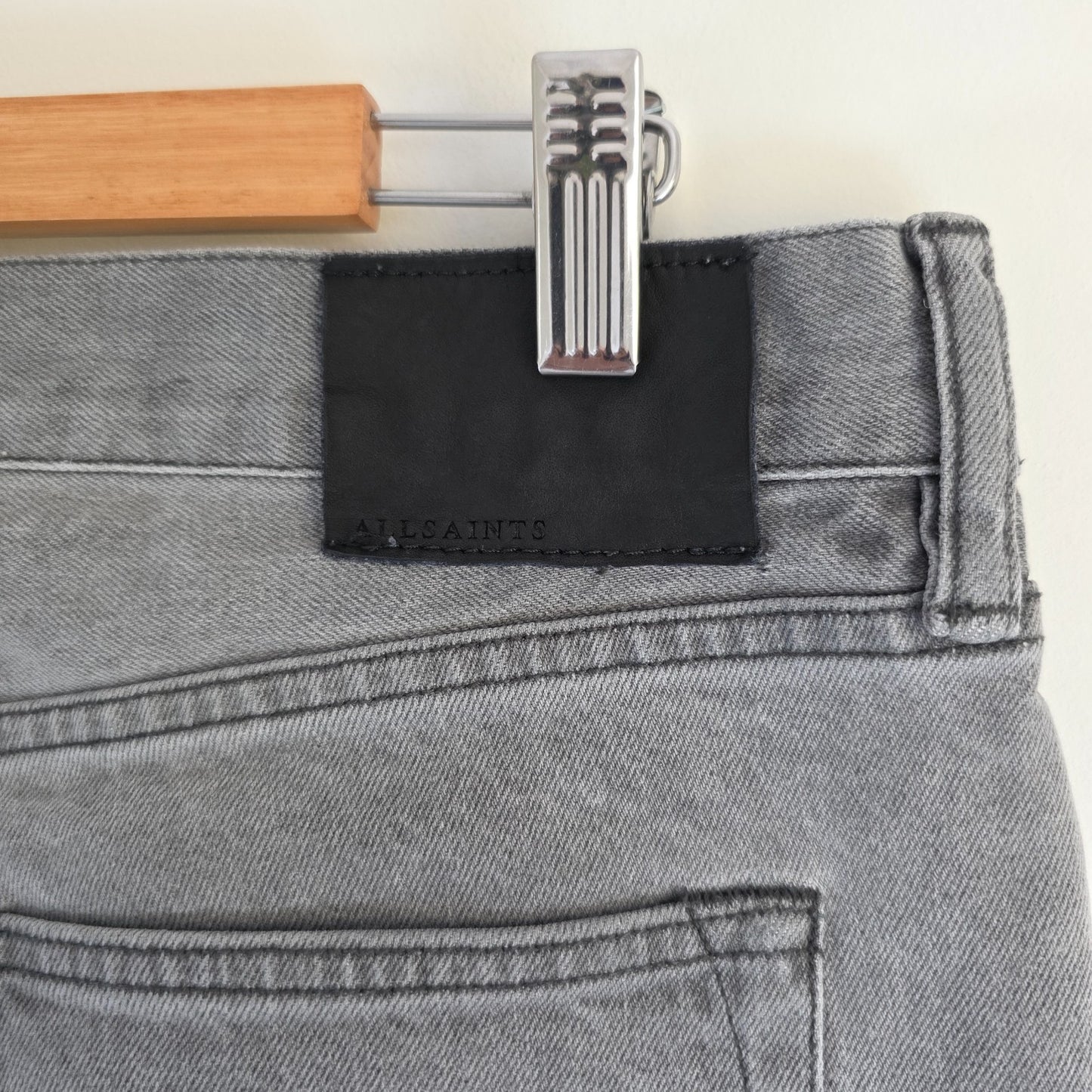 AllSaints grey slim jeans with button fly and stretch cotton elastane blend.