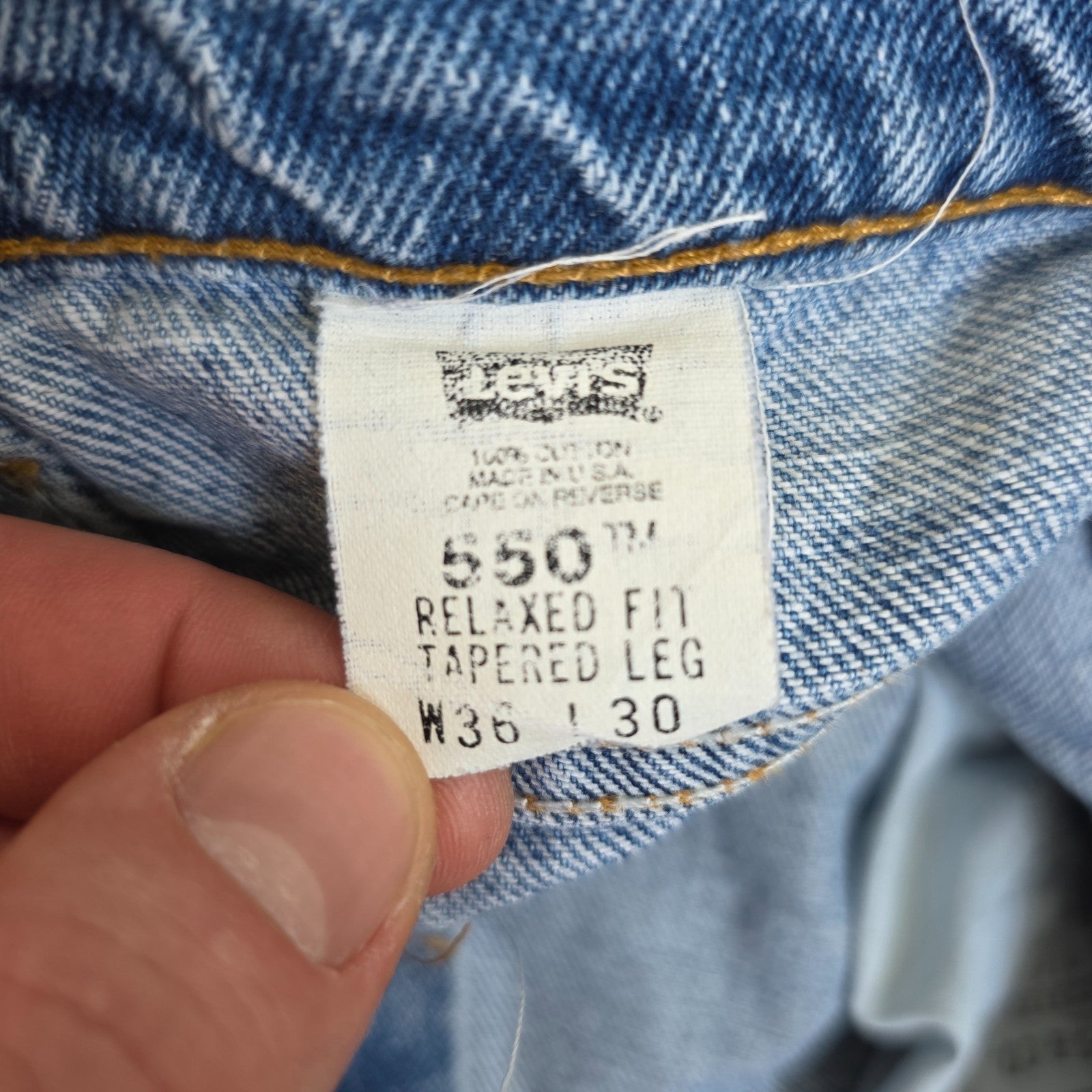 Levi's blue straight jeans vintage 550 relaxed fit with classic 90s silhouette.