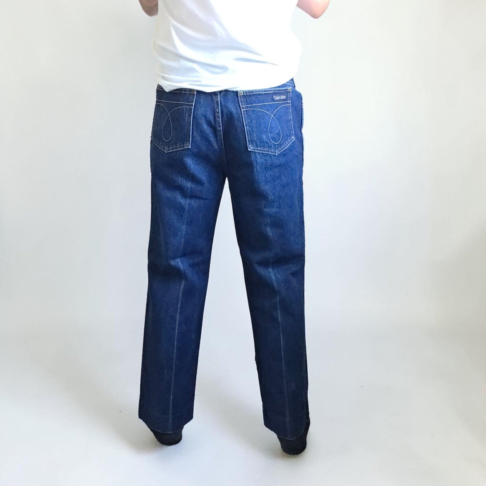 Calvin Klein blue straight leg jeans with vintage 90s style and cotton material.