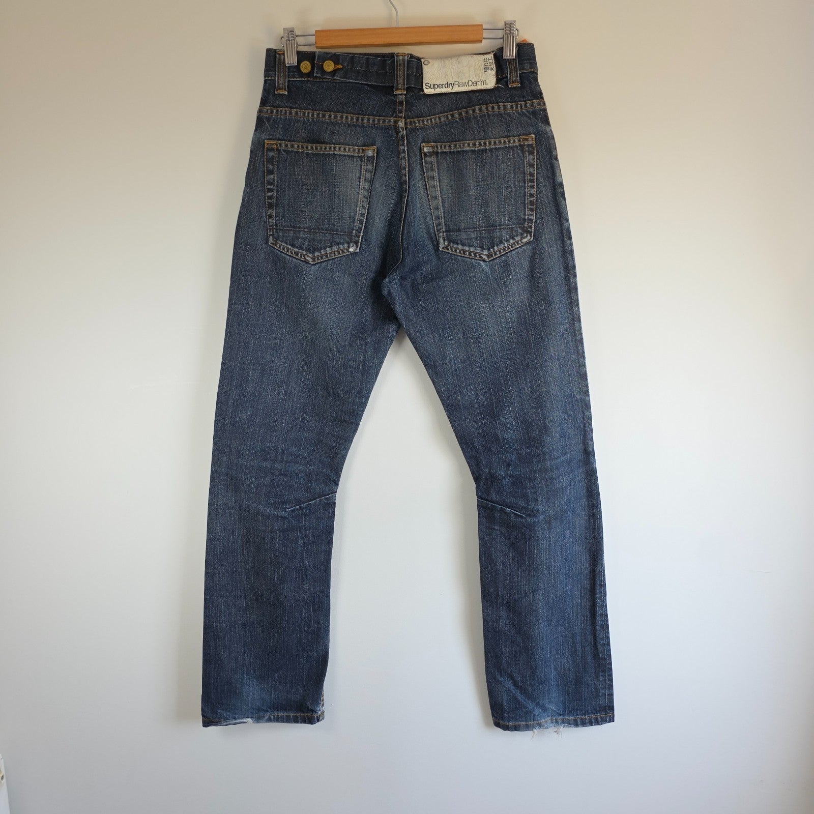 Superdry blue straight jeans with button fly, vintage raw denim, light wear.