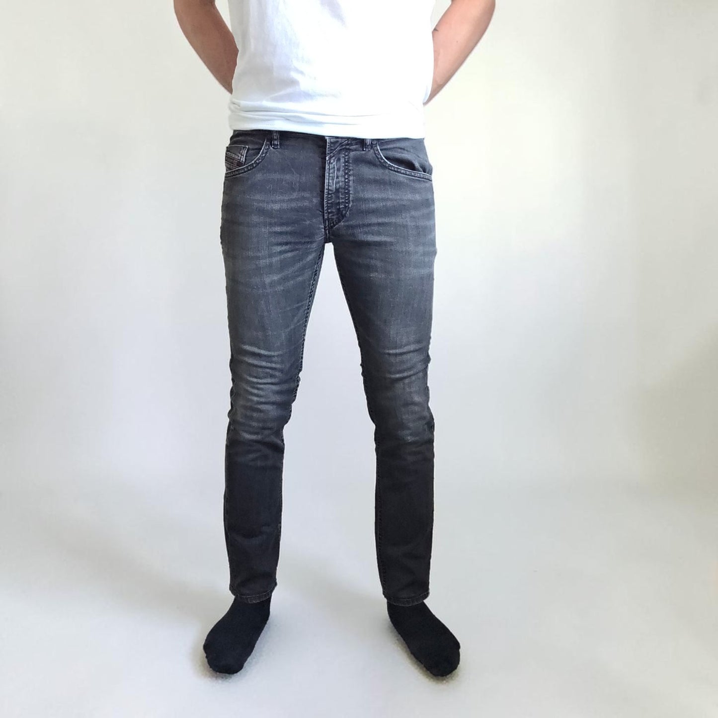 Diesel black straight jeans with grey wash, stretch denim, and branded tag.