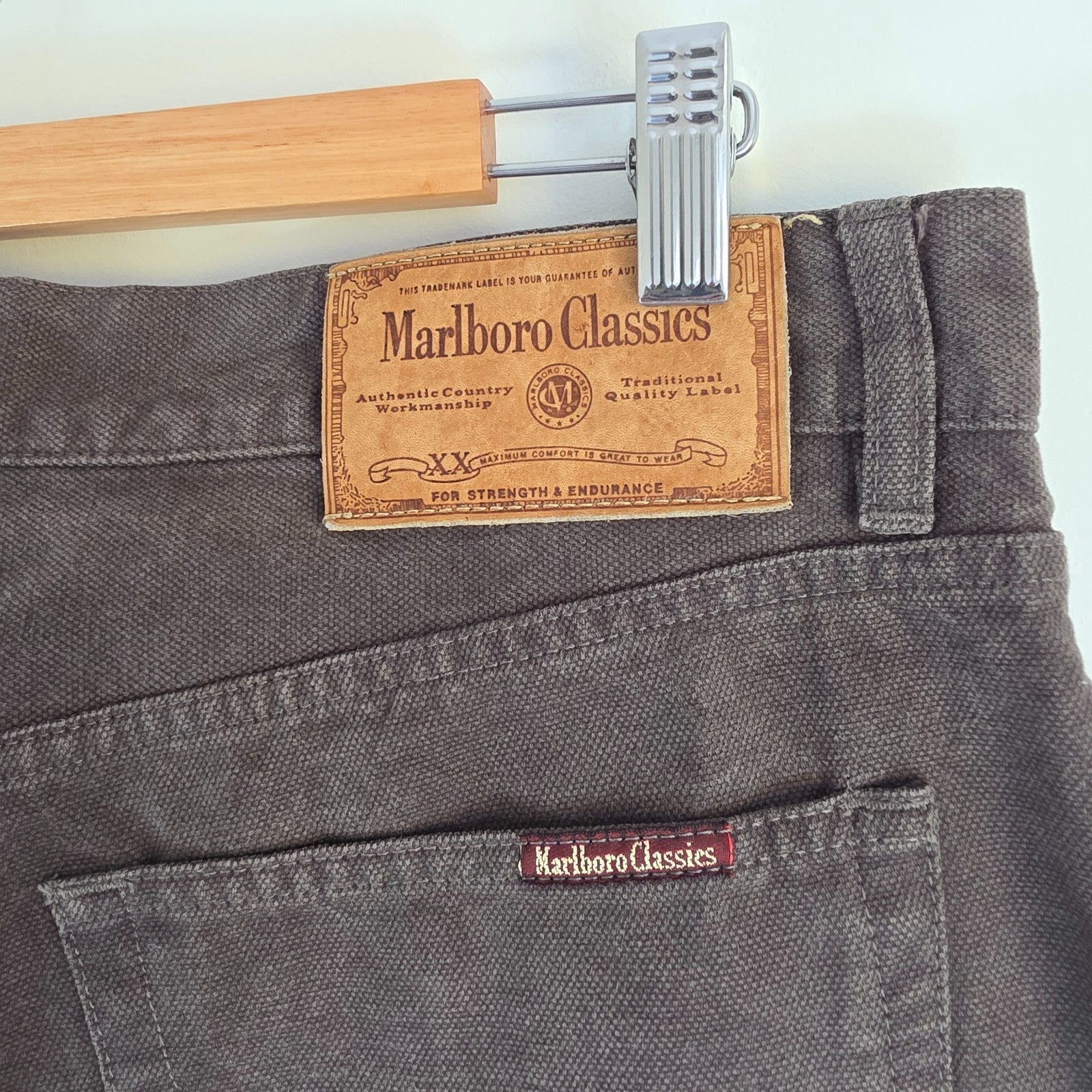 Marlboro Classics grey straight jeans with button fly and vintage logo detail.