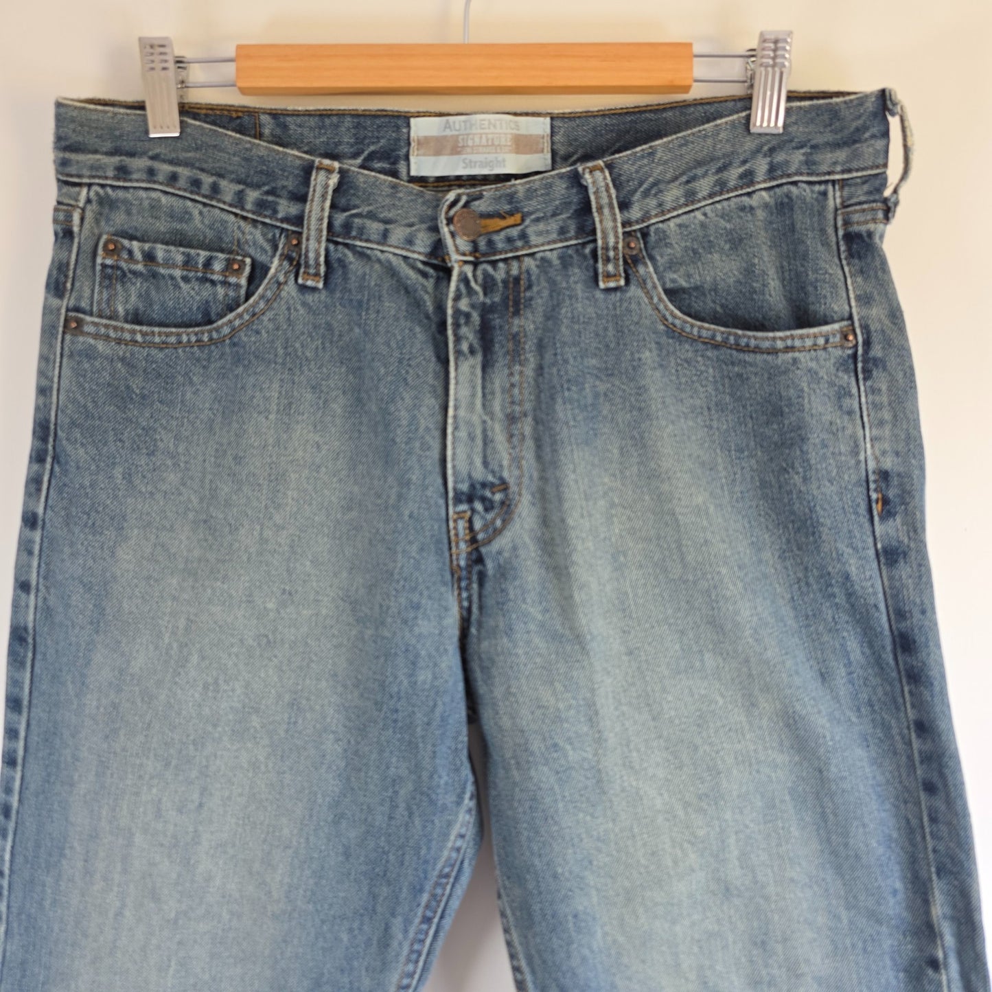 Levi's blue straight leg jeans, cotton material, missing back waist patch, casual style.