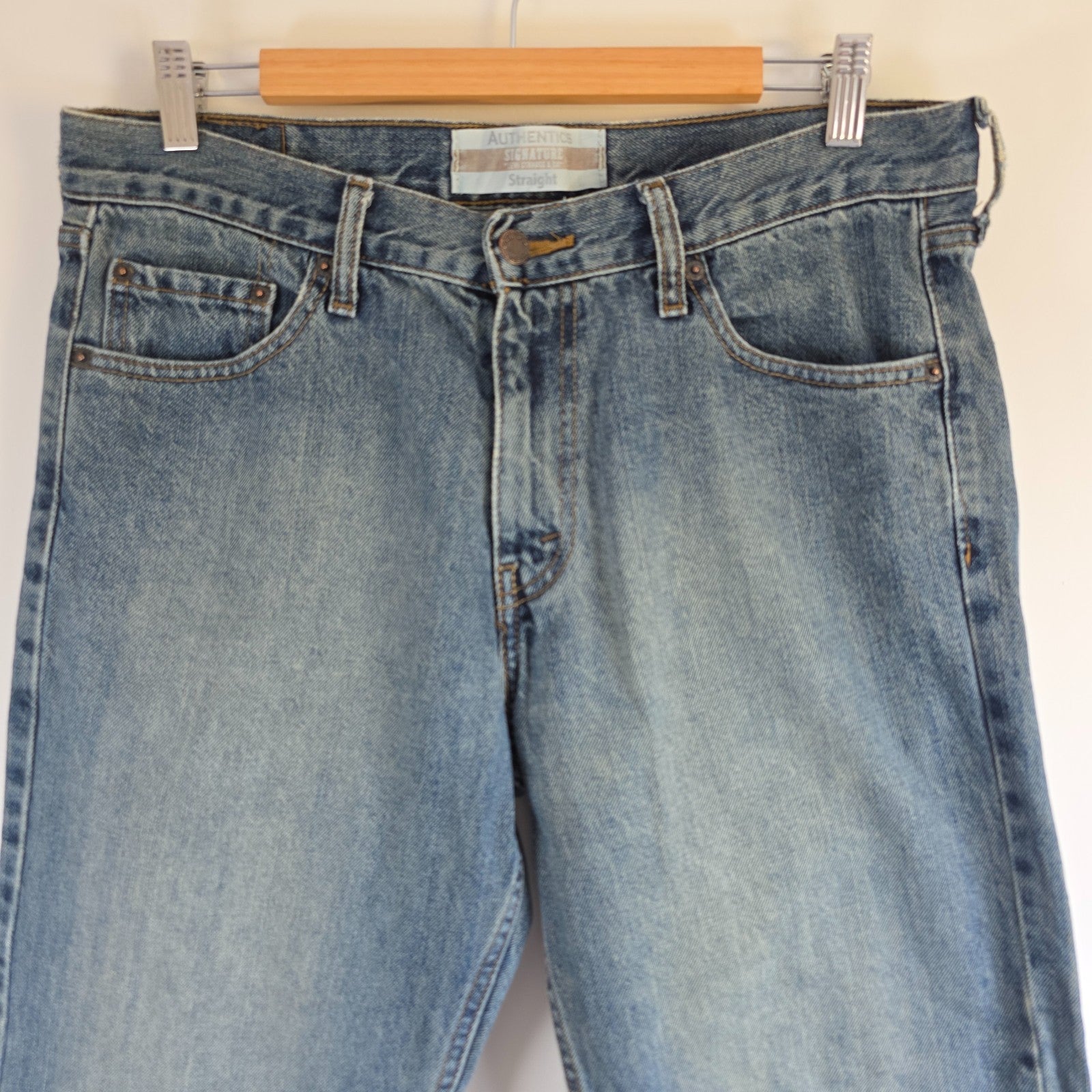 Levi's blue straight leg jeans, cotton material, missing back waist patch, casual style.