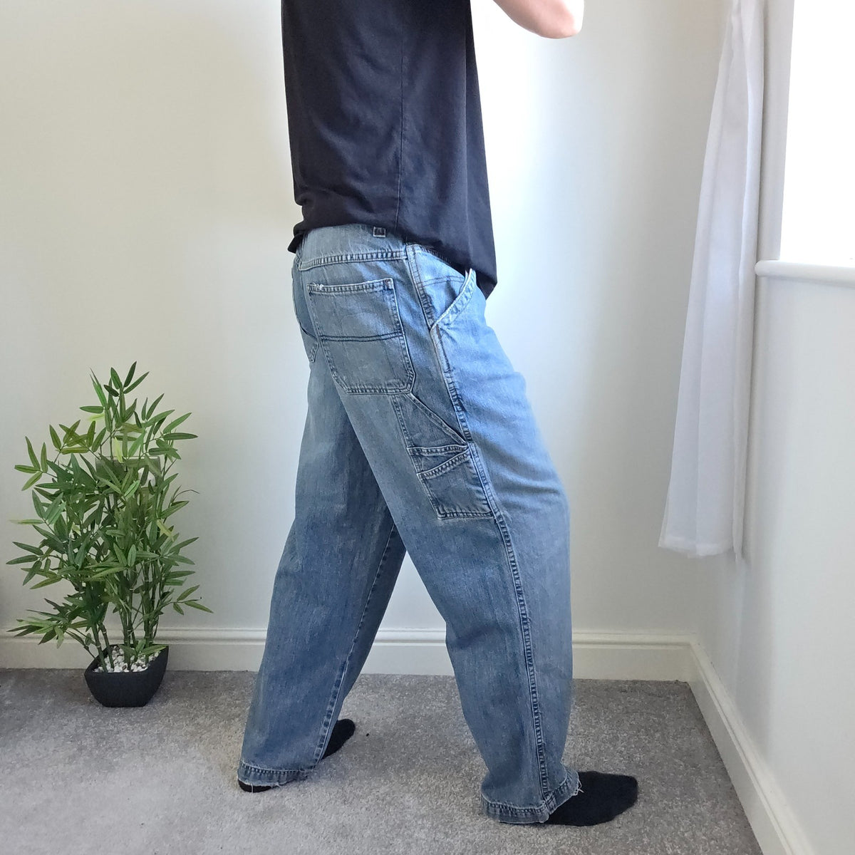 Old Navy blue carpenter jeans with hammer loop and utility pocket detailing.