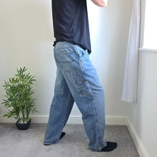 Old Navy blue carpenter jeans with hammer loop and utility pocket detailing.