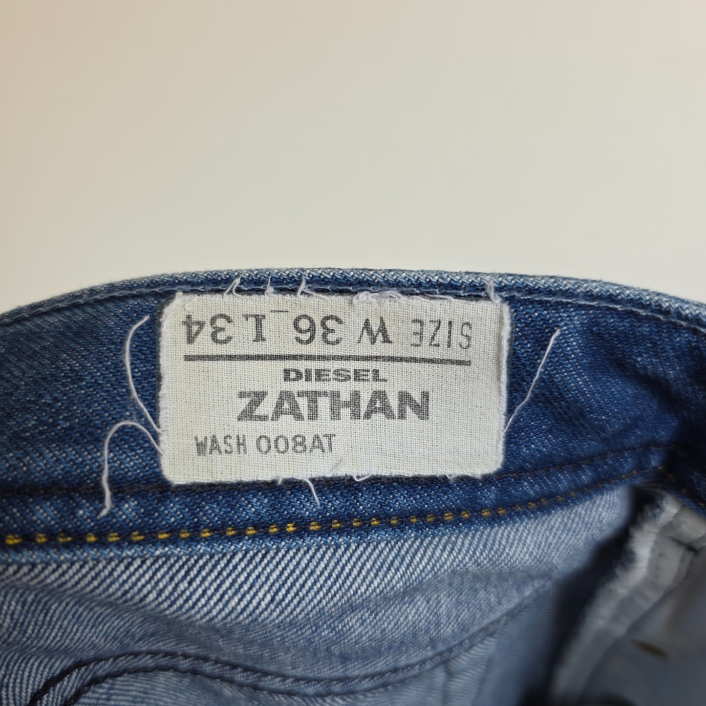 Diesel blue bootcut jeans with button fly and vintage Zathan fit, 100% cotton.