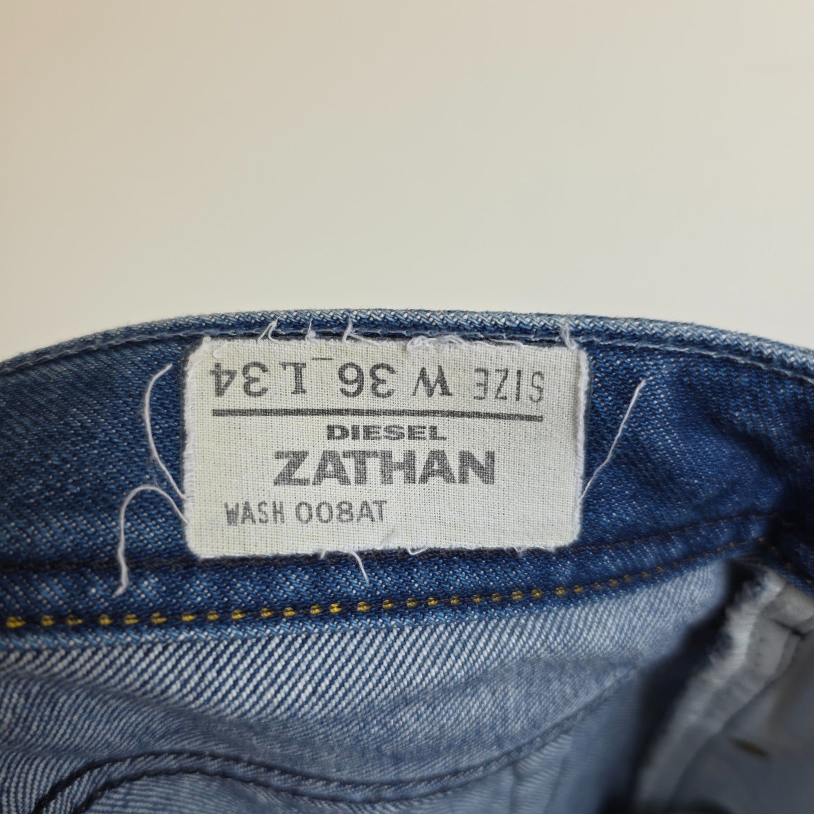 Diesel blue bootcut jeans with button fly and vintage Zathan fit, 100% cotton.