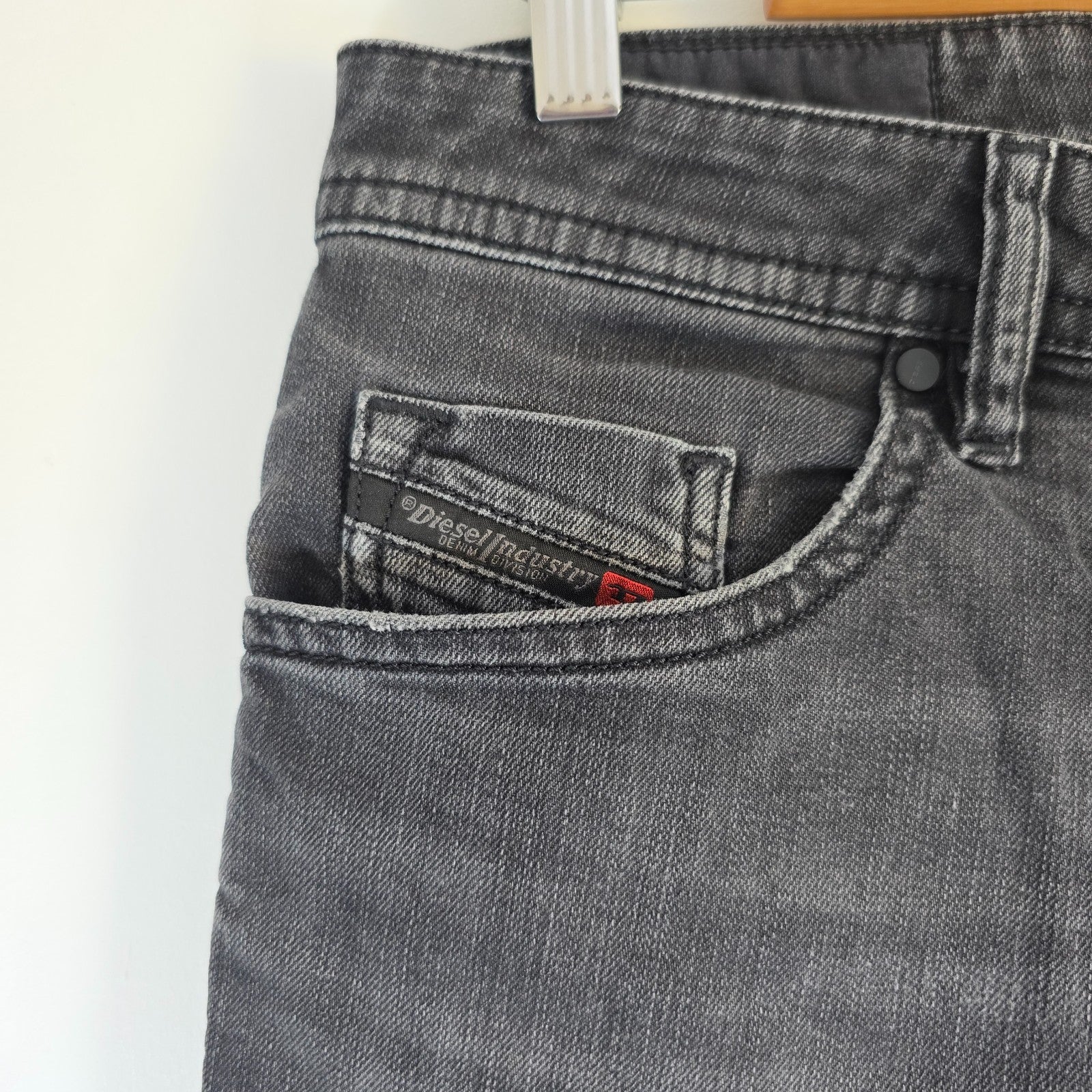 Diesel black straight jeans with grey wash, stretch denim, and branded tag.