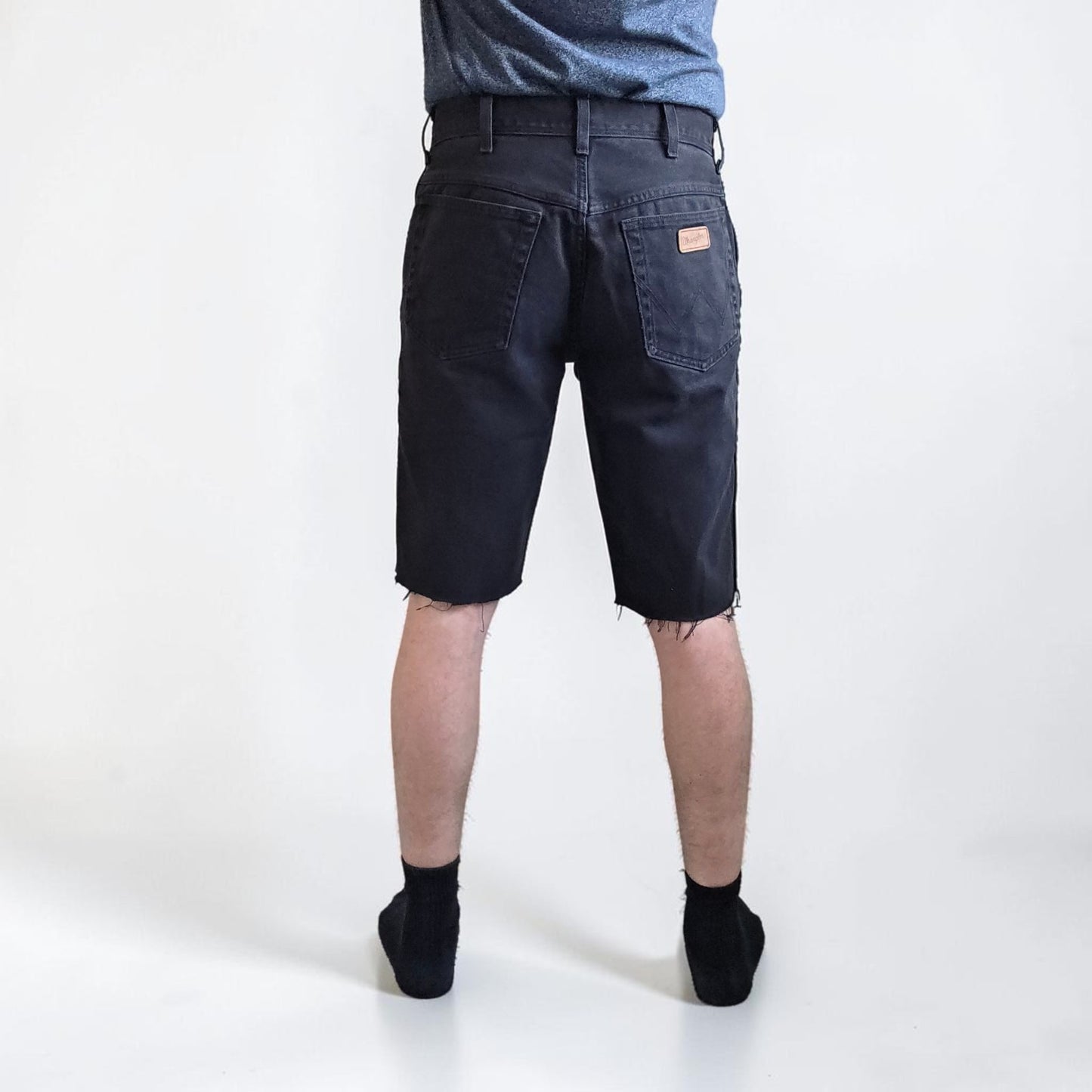 Wrangler black denim shorts W33 with frayed hems and copper-toned button.