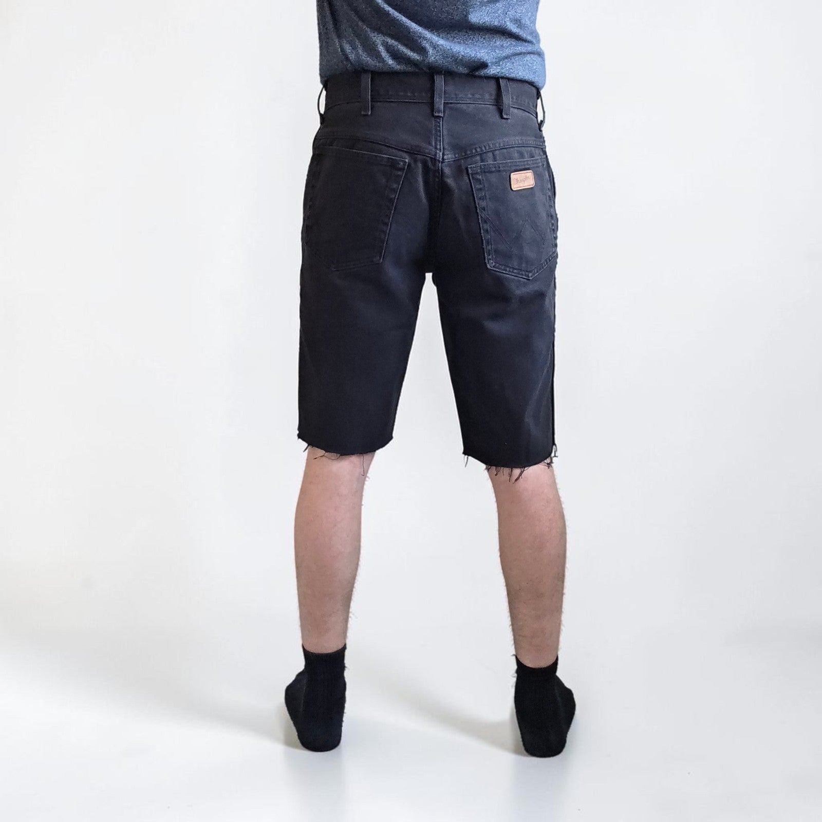 Wrangler black denim shorts W33 with frayed hems and copper-toned button.