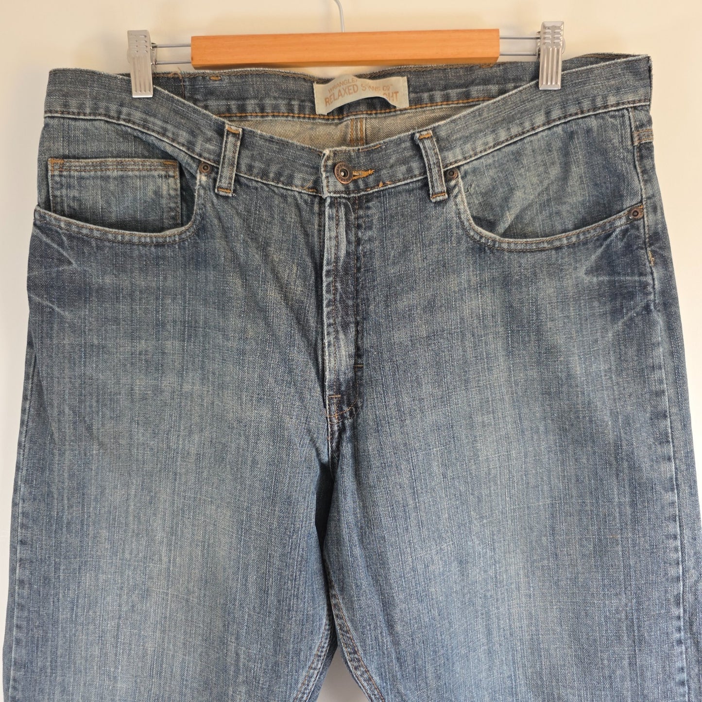 Wrangler blue straight jeans with relaxed fit, 100% cotton, professional hemmed to 30 inches.