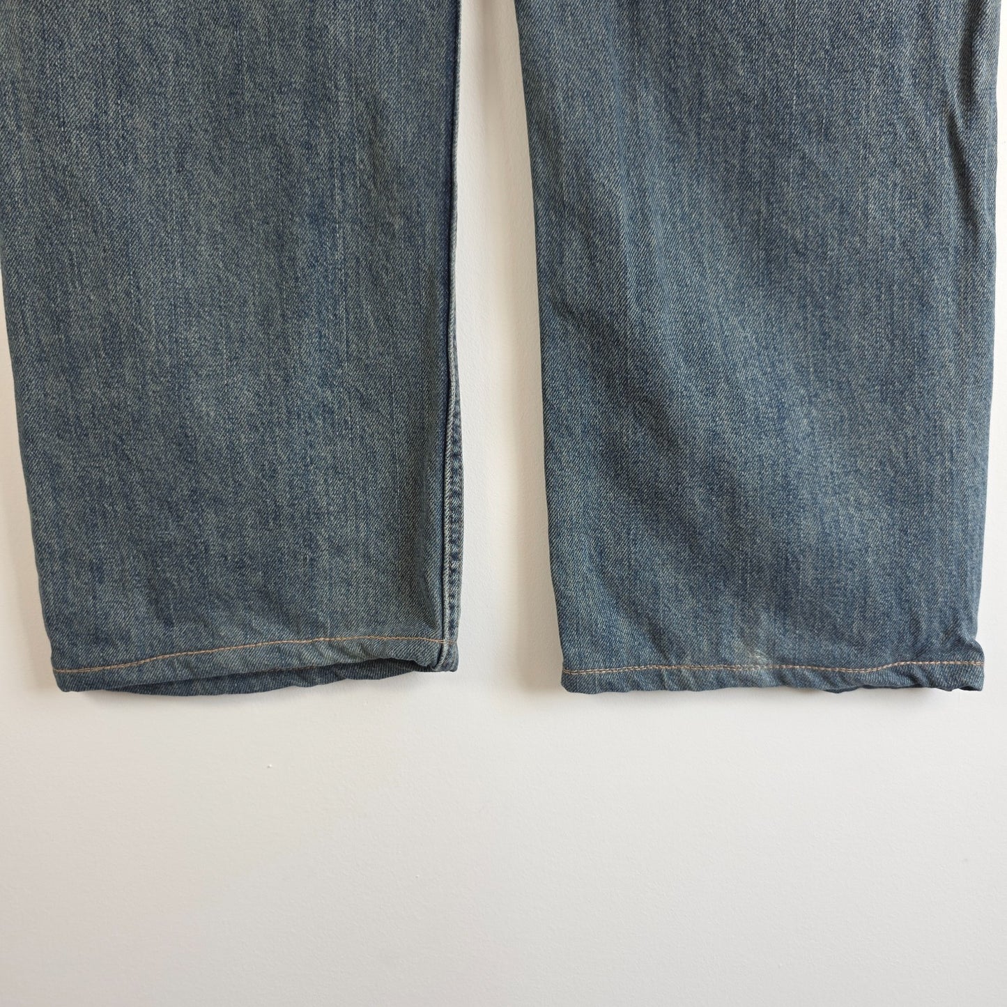Levi's blue straight leg jeans, cotton material, missing back waist patch, casual style.