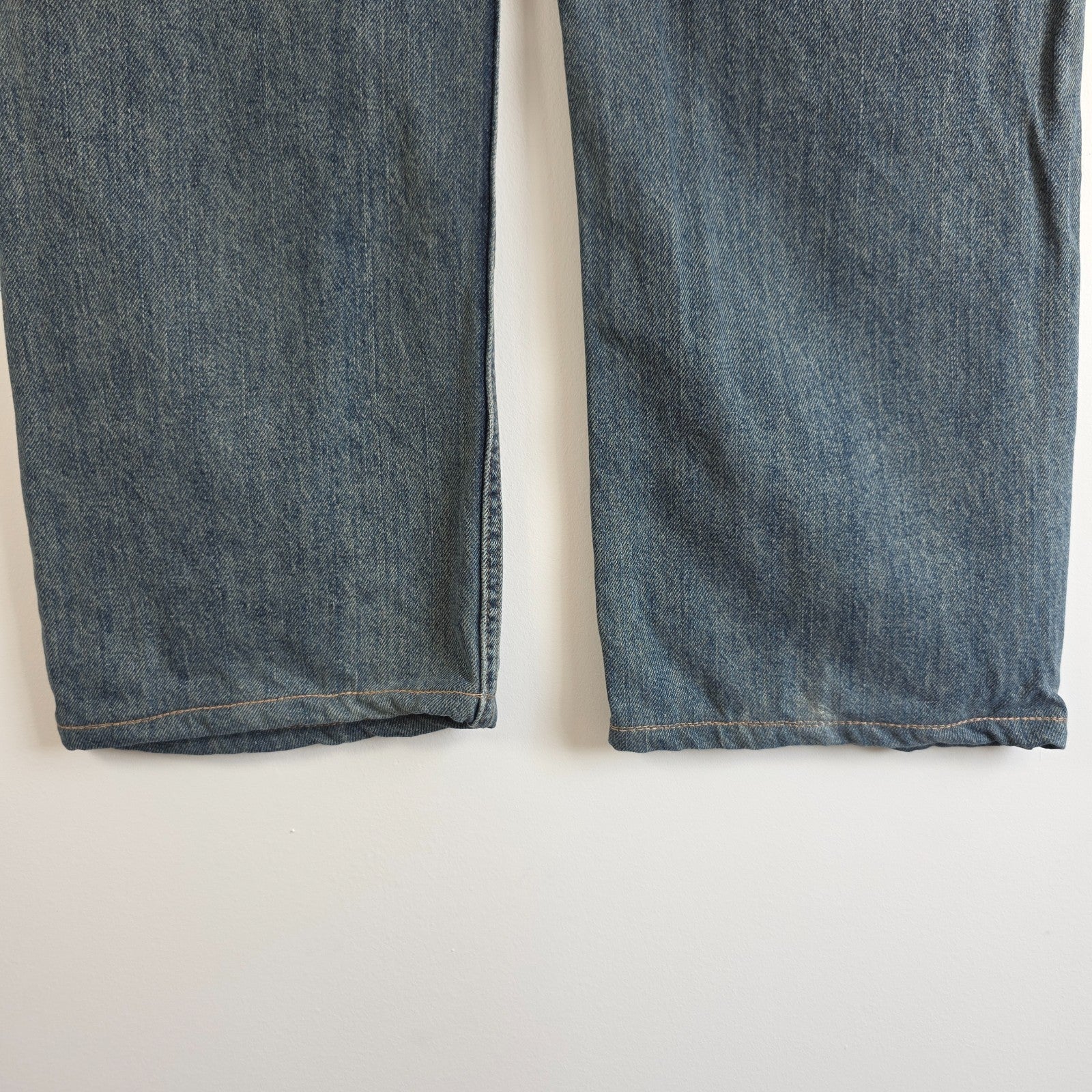 Levi's blue straight leg jeans, cotton material, missing back waist patch, casual style.