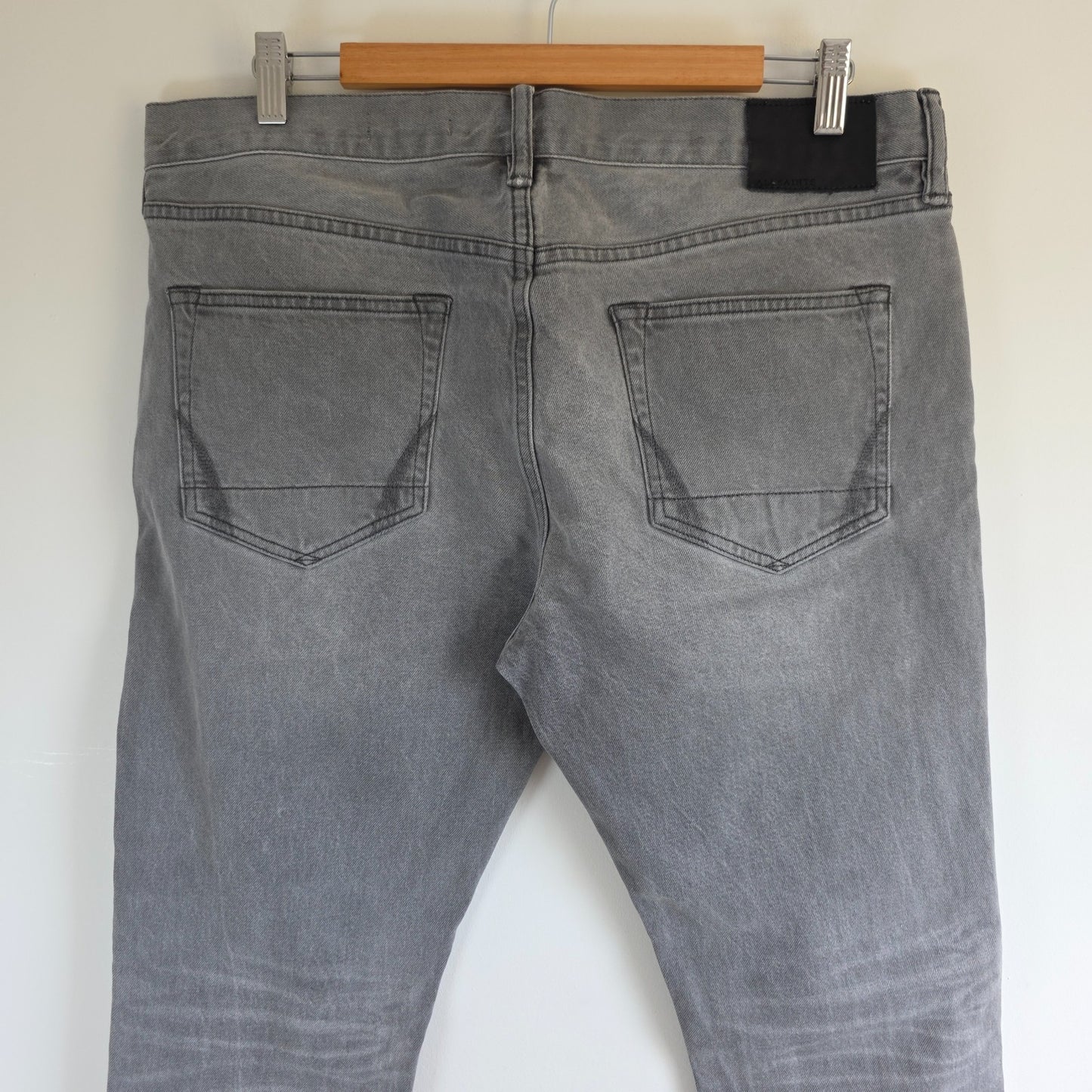 AllSaints grey slim jeans with button fly and stretch cotton elastane blend.