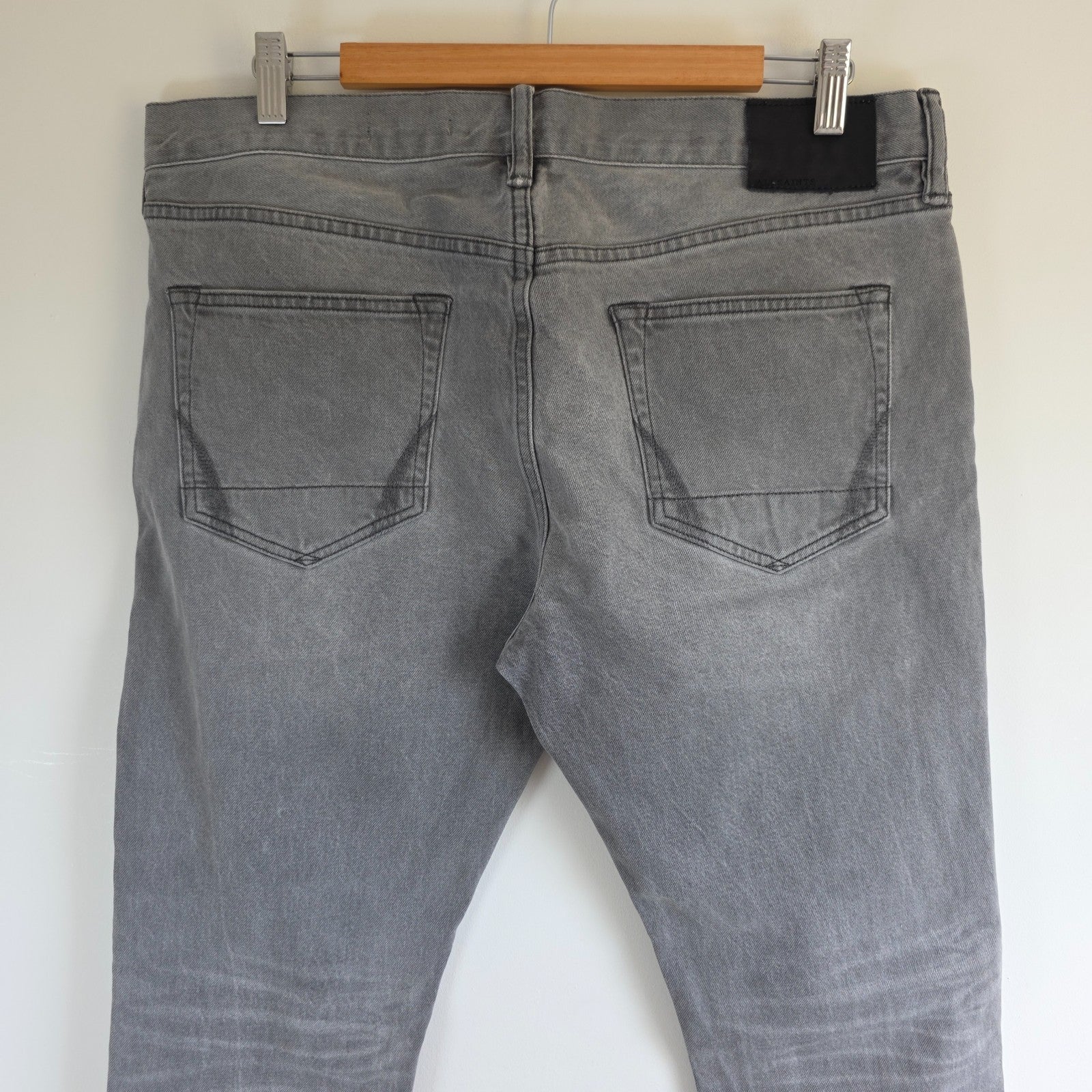 AllSaints grey slim jeans with button fly and stretch cotton elastane blend.